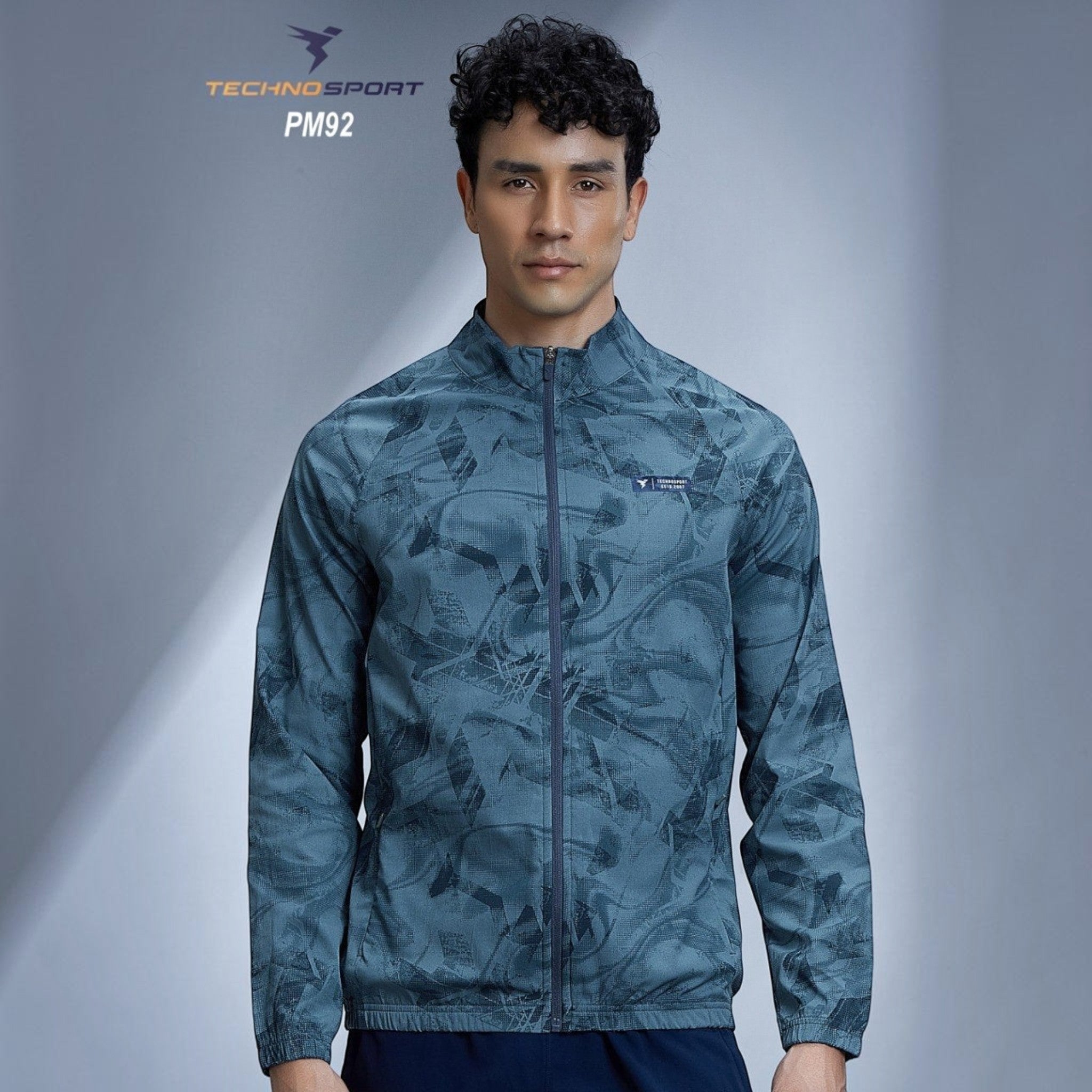 City Center Technosport full-sleeve hi-neck jacket in blue with an all-over abstract print and odour-free fabric.