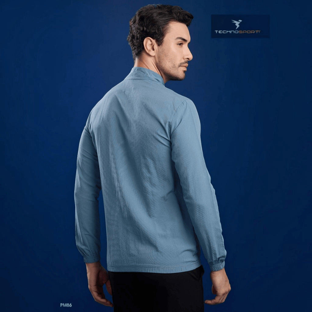 City Center Technosport blue slim-fit hi-neck lightweight woven jacket worn by a man against a blue background