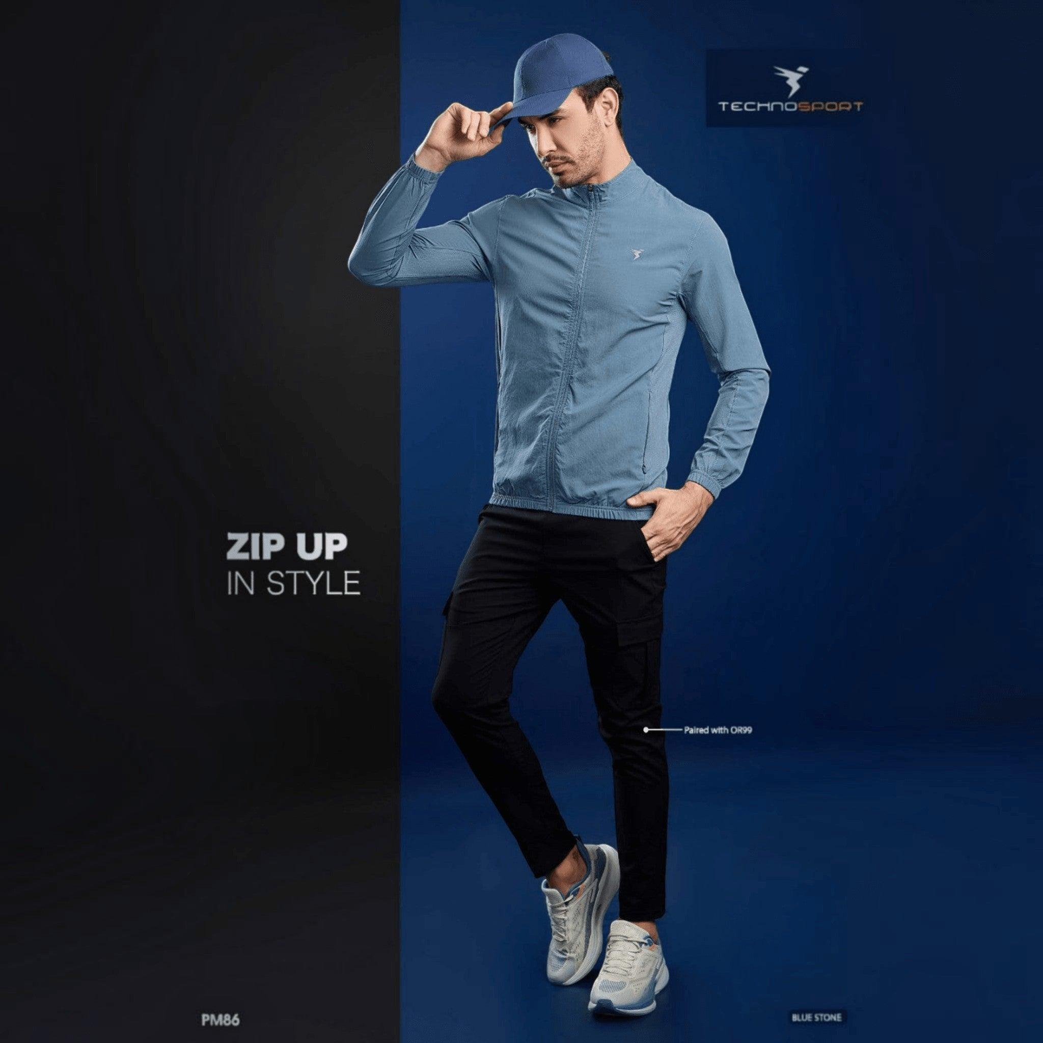 City Center Technosport blue lightweight hi-neck slim-fit jacket worn by a model with a cap and black trousers