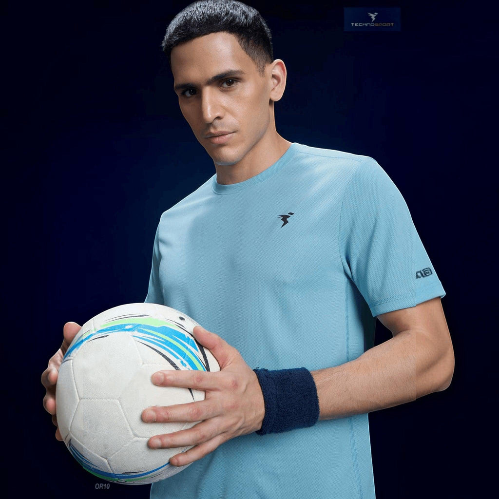 City Center Technosport light blue slim fit crew neck t-shirt with TechnoCool+ fabric worn by a man holding a ball
