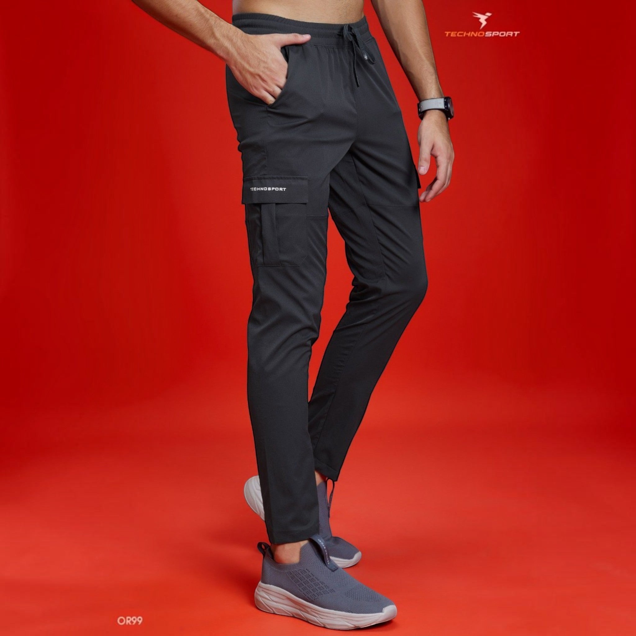 City Center Technosport TS Flexi solid woven charcoal grey cargo pants with side pockets on a model against red