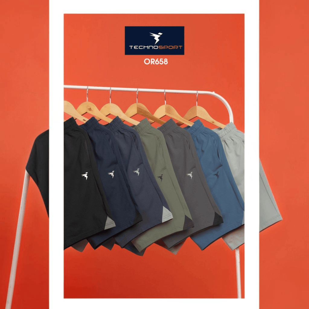 City Center Technosport 4-way stretch crispy shorts in various solid colors hanging on a rack for activewear.