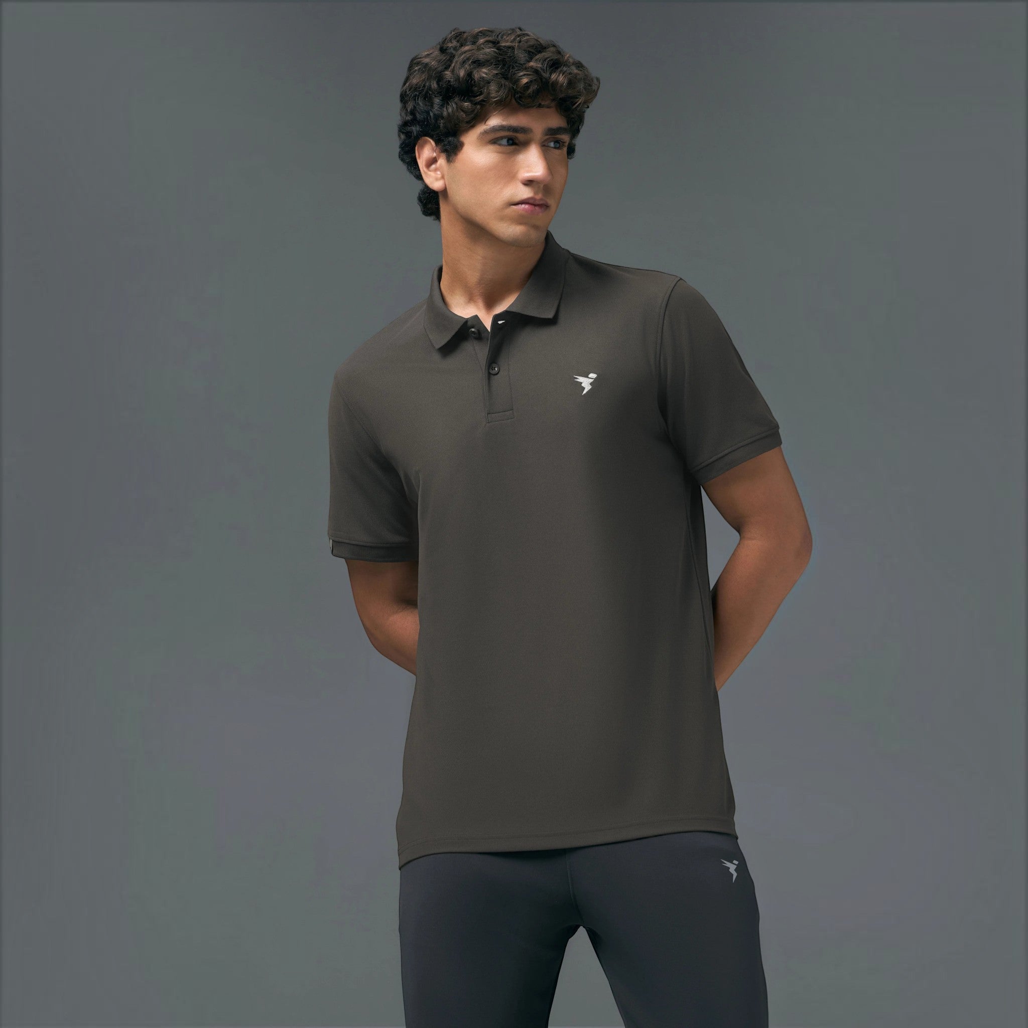 City Center TechnoSport OR-11 dark grey dry fit polo shirt with button placket worn by a man against a grey background