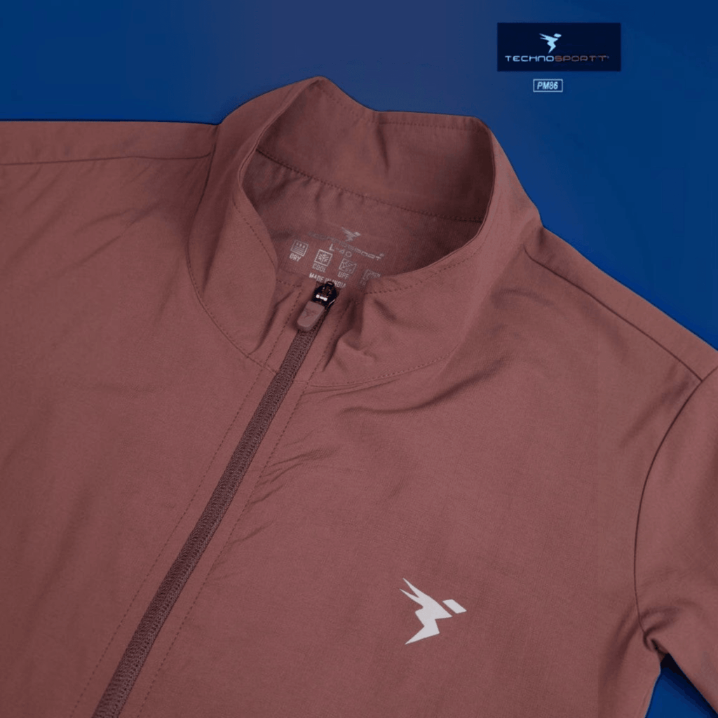 City Center Technosport TS Flexi Jacket in dusty rose with a front zipper, high collar, and moisture-wicking fabric.