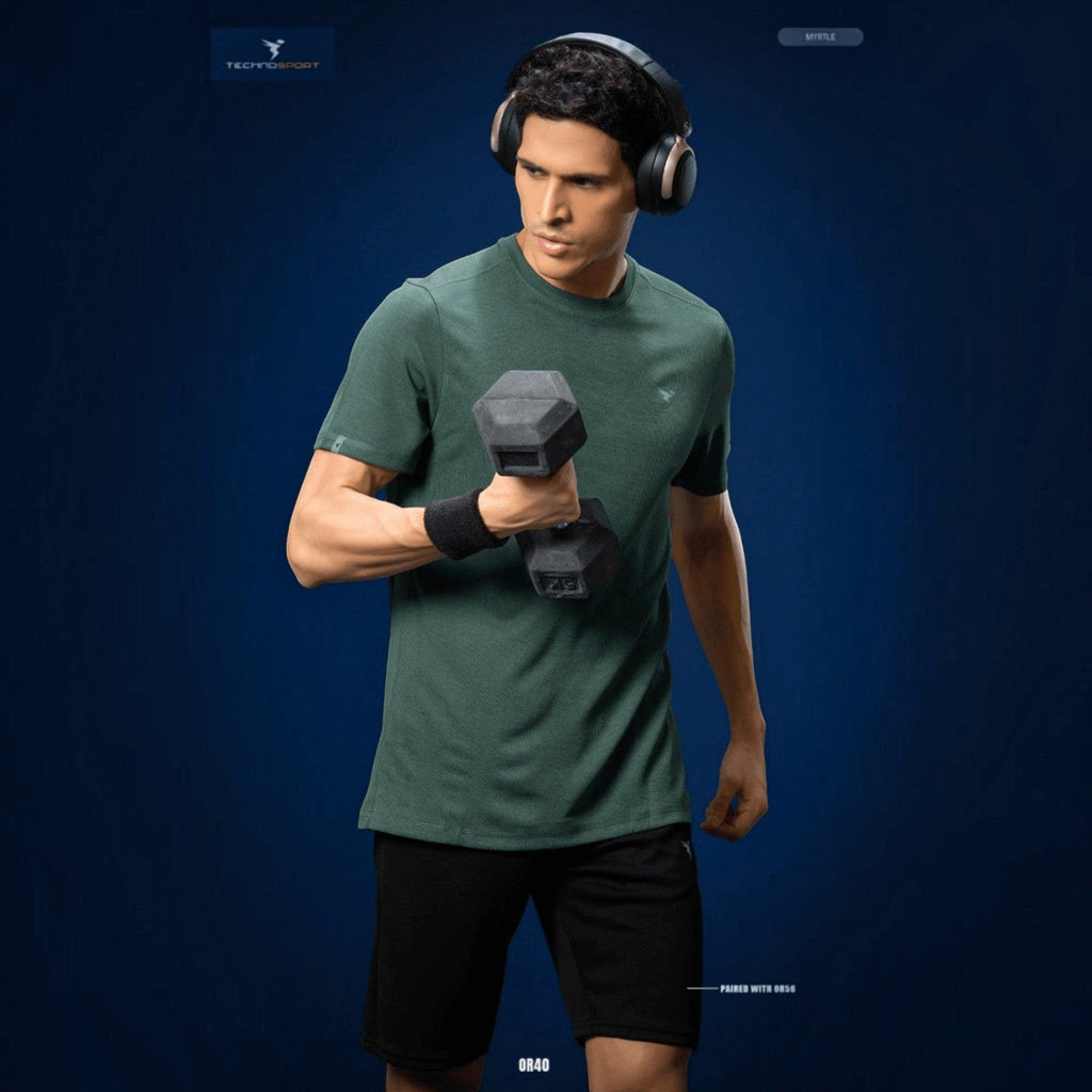 City Center Technosport green athletic crew neck t-shirt with moisture-wicking fabric worn by a man lifting a dumbbell