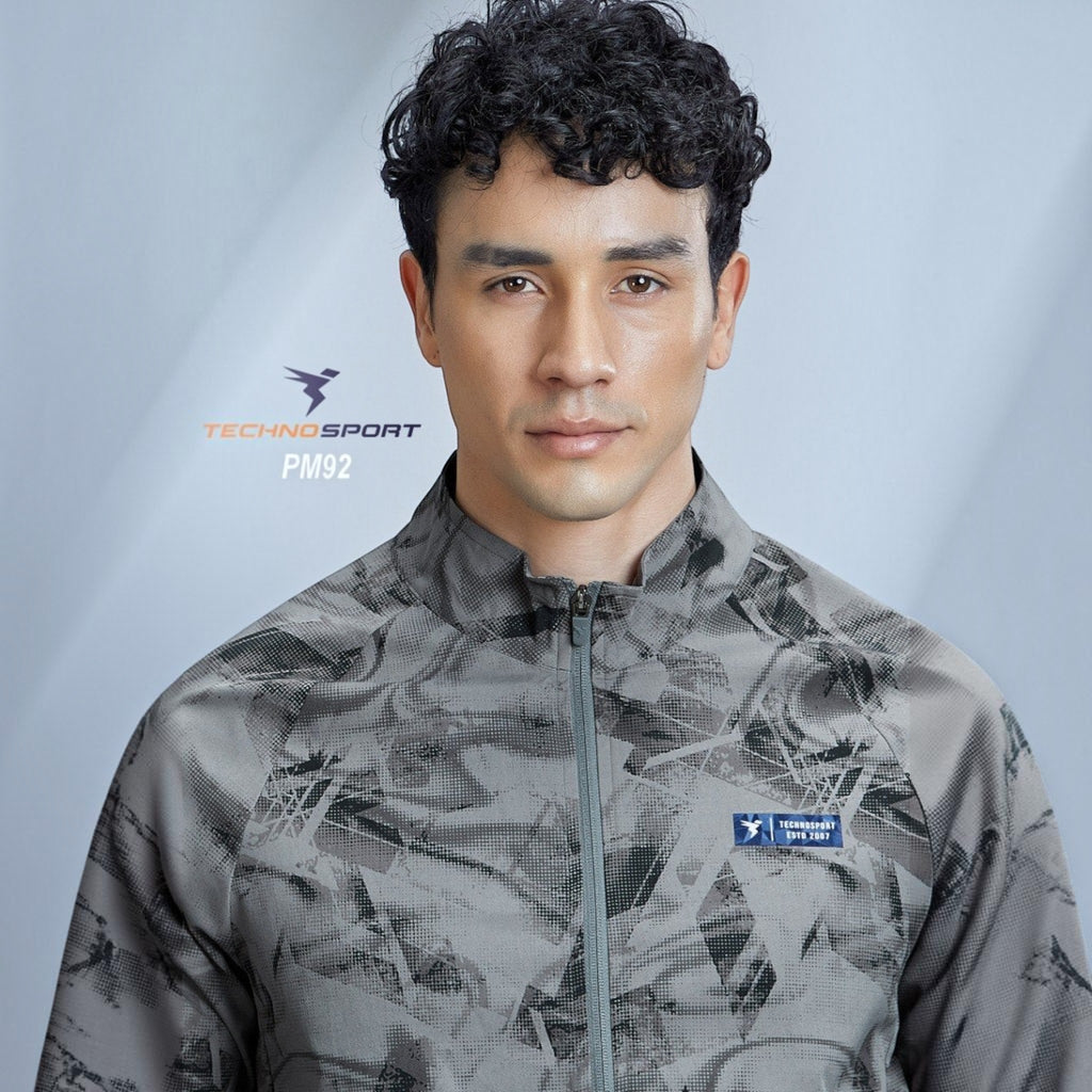 City Center model wearing a grey Technosport high-neck jacket with an all-over abstract print and full sleeves.