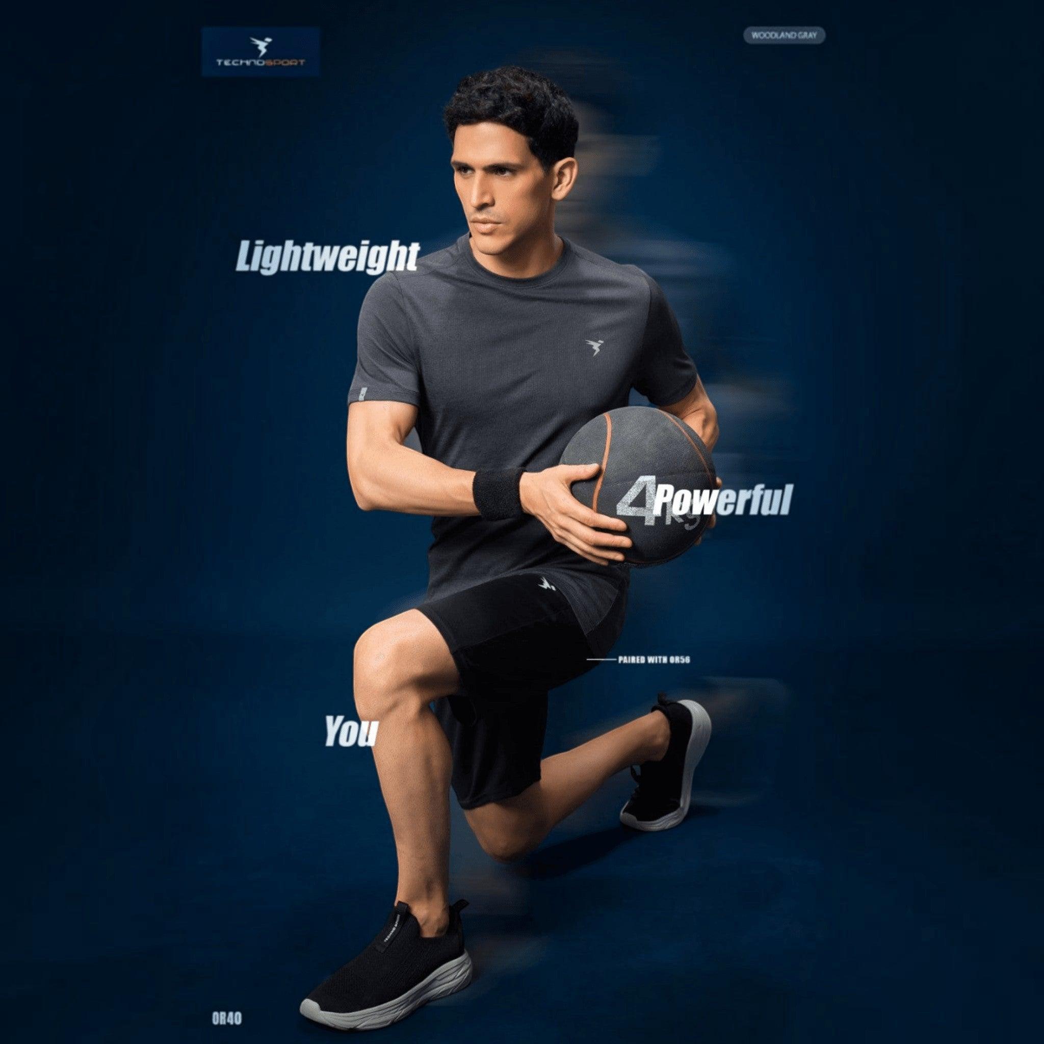 City Center Technosport grey athletic crew neck t-shirt with moisture-wicking fabric worn by a man holding a medicine ball
