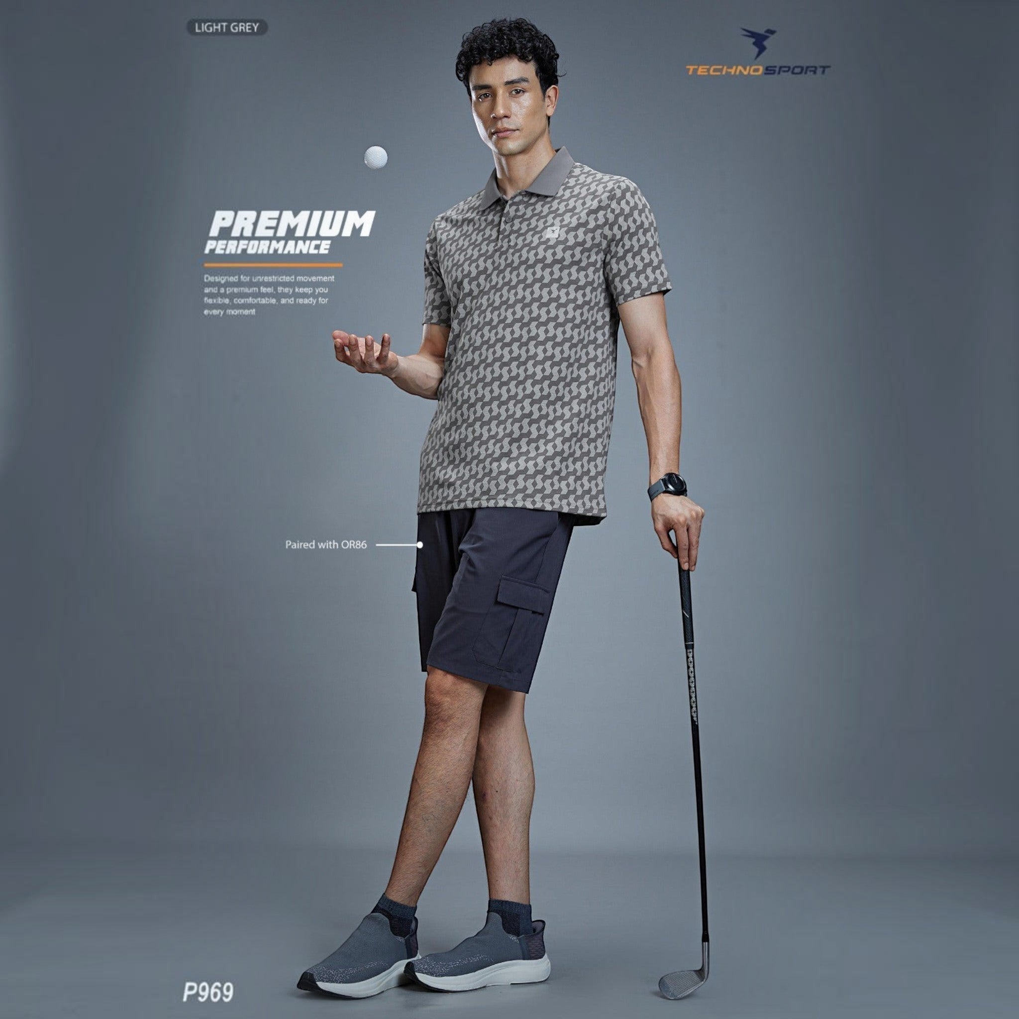 City Center Technosport P969 light grey patterned polo shirt worn by a male model holding a golf club
