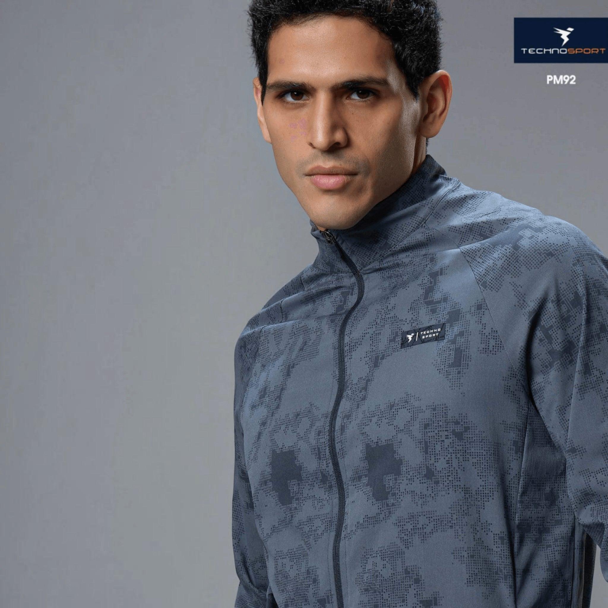 City Center Technosport men's grey hi-neck jacket with all-over print, featuring 2-way stretch and moisture-wicking fabric.