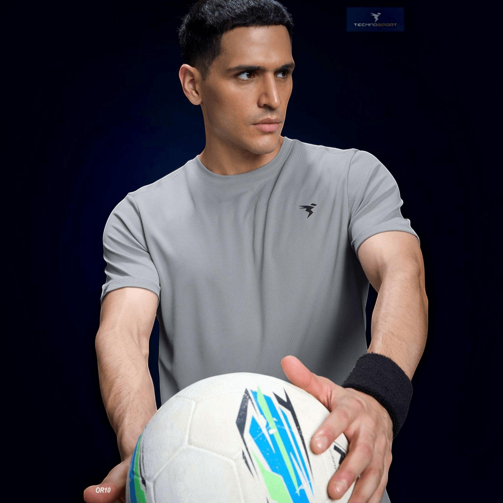 City Center Technosport grey crew neck slim fit performance t-shirt worn by a man holding a soccer ball