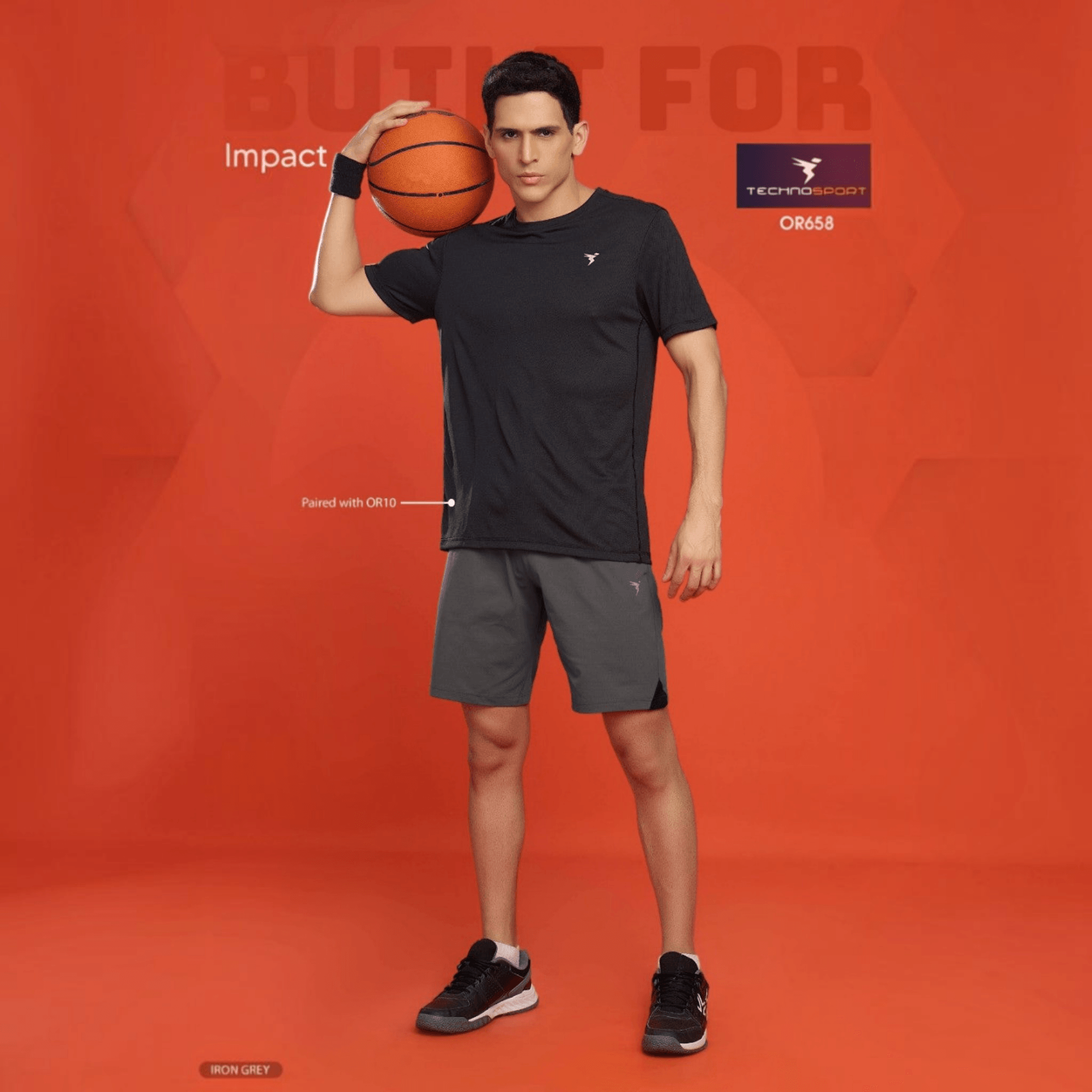 City Center model wearing Technosport iron grey 4-way stretch athletic shorts with a black t-shirt and basketball