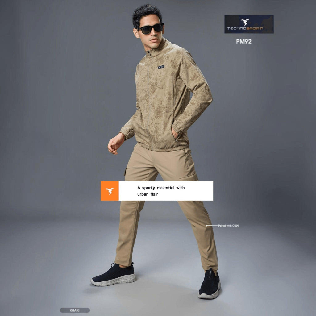 City Center Technosport khaki camo print hi-neck zip-up jacket worn by a man with sunglasses and tan trousers