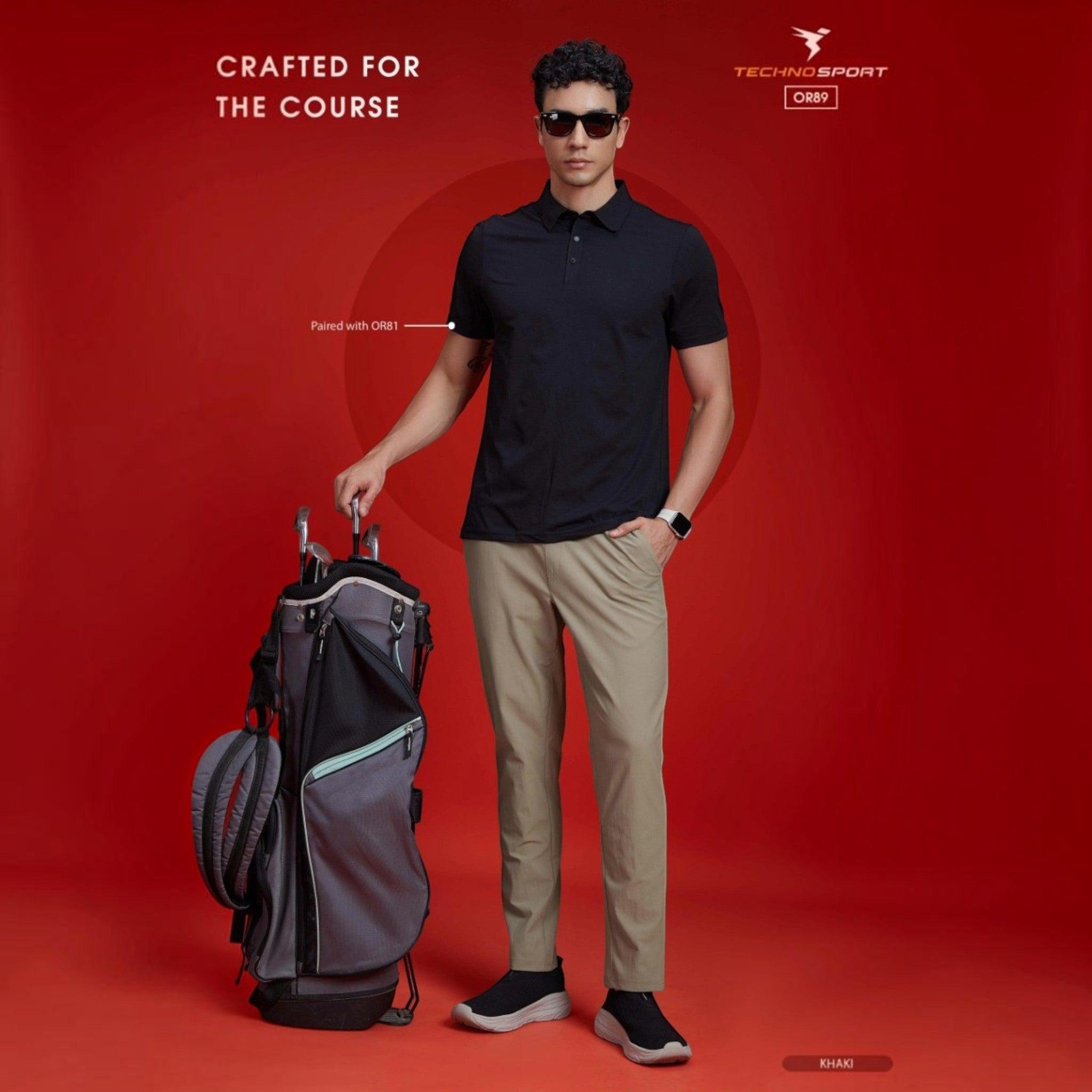 City Center Technosport khaki 4-way stretch track pants worn by a male golfer with a golf bag on a red background