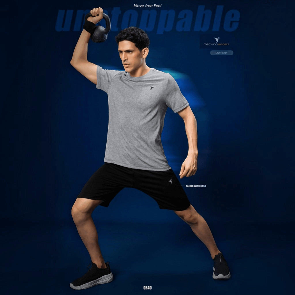 City Center Technosport light grey athletic crew neck t-shirt with moisture-wicking fabric on a man lifting a kettlebell