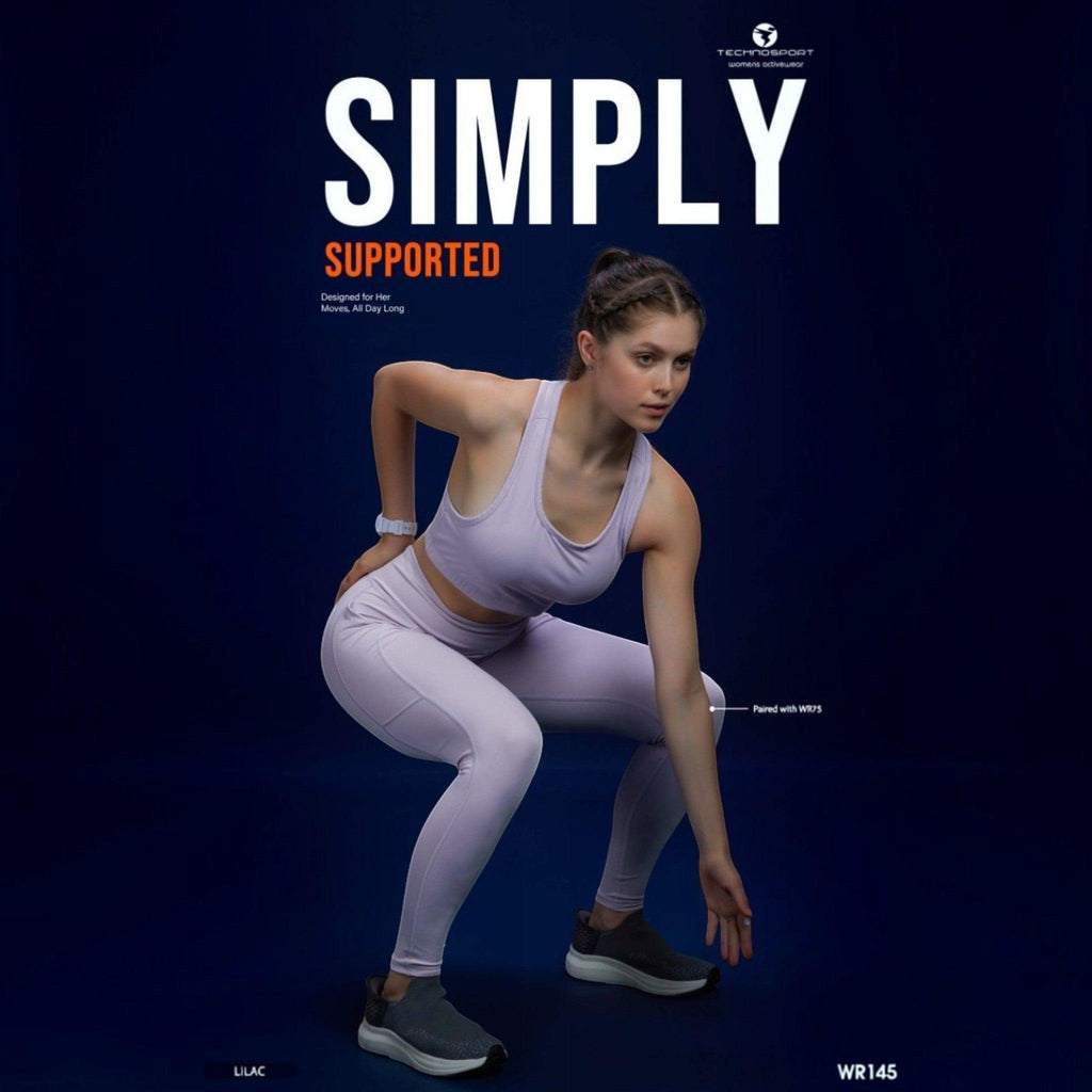 City Center Technosport Elastoplus lilac racer back sports bra worn by a woman in a squat position