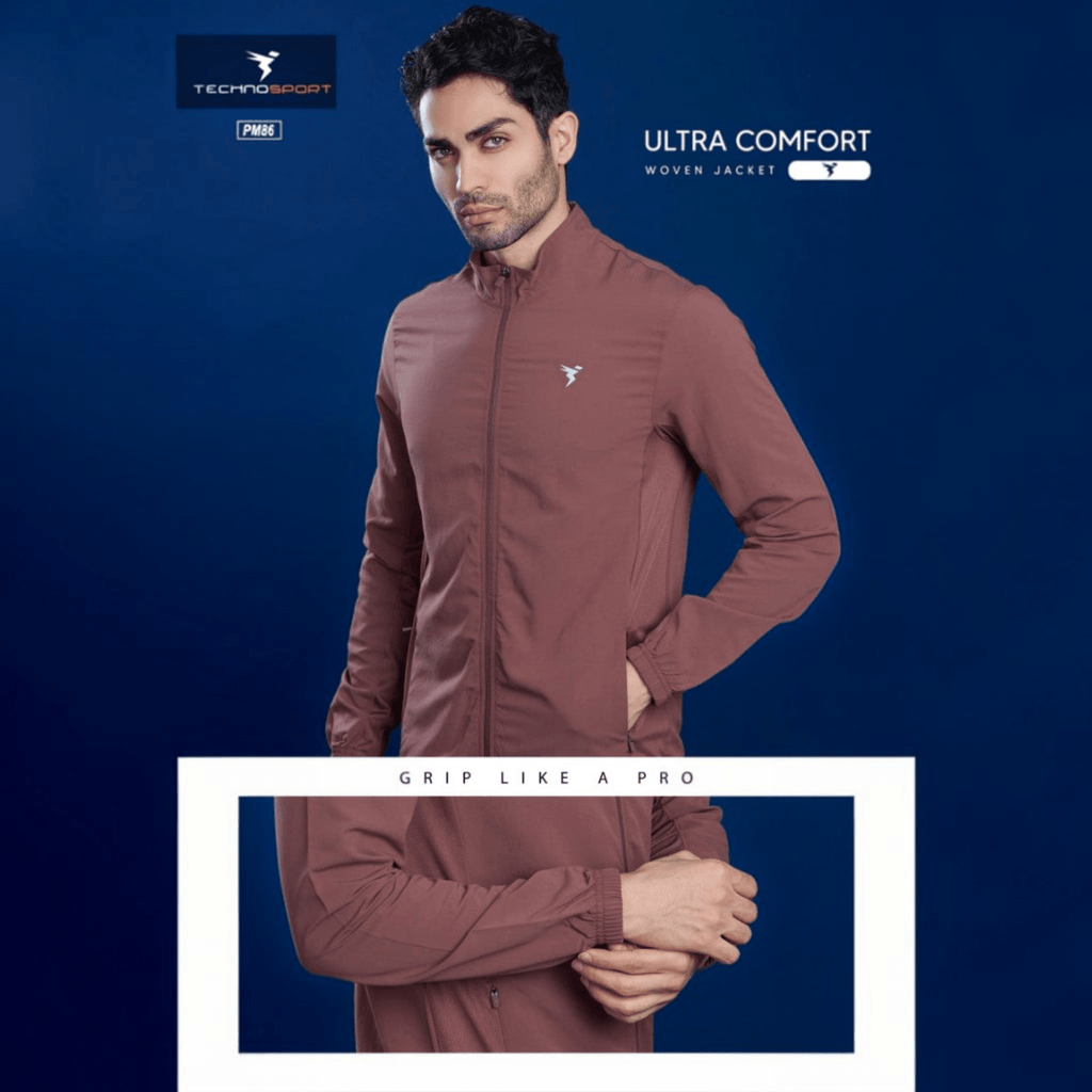 City Center Technosport TS Flexi mauve performance jacket with zip-up front, worn by a man against a blue background.
