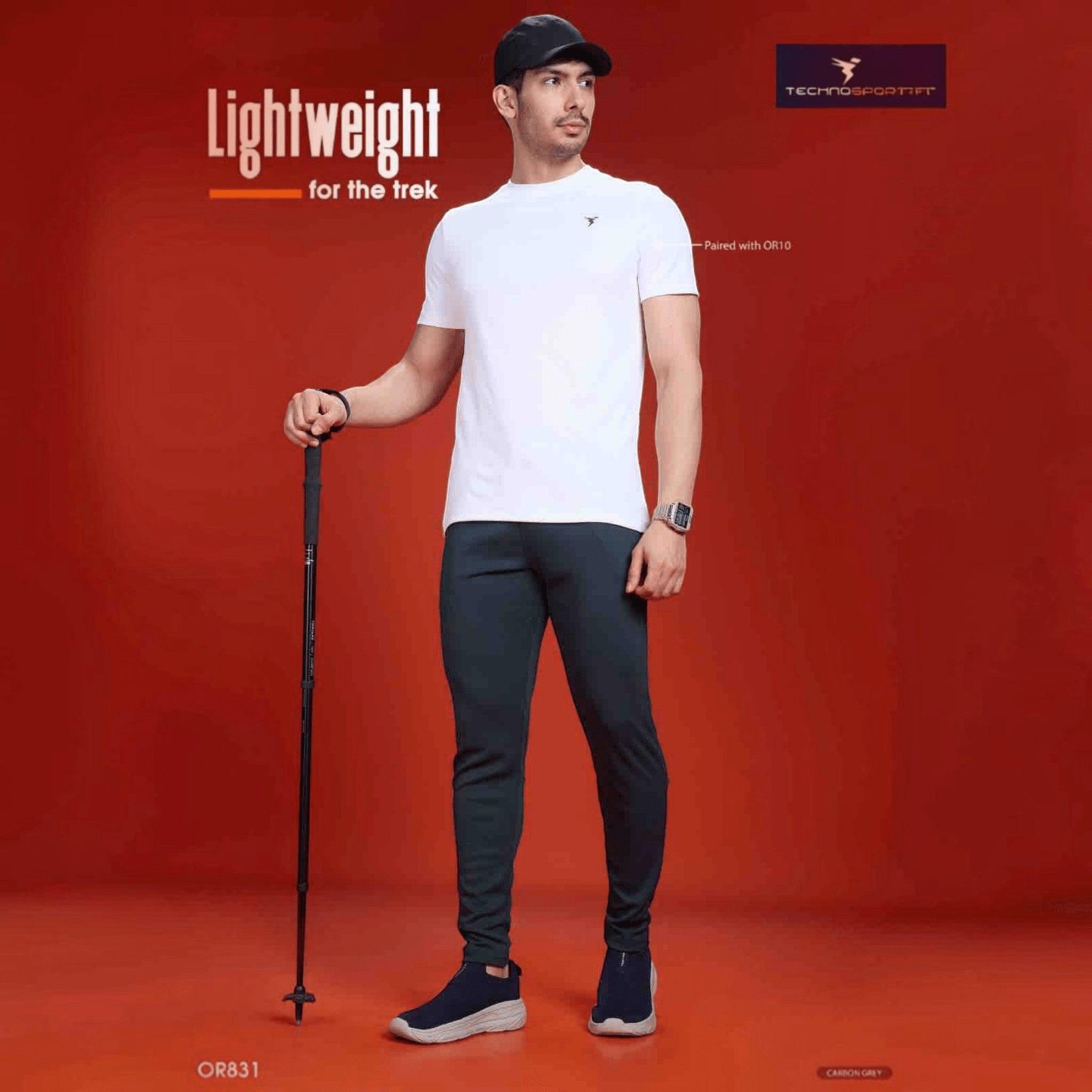 City Center Technosport men's slim fit carbon grey track pants worn by a model with a white t-shirt and trekking pole.