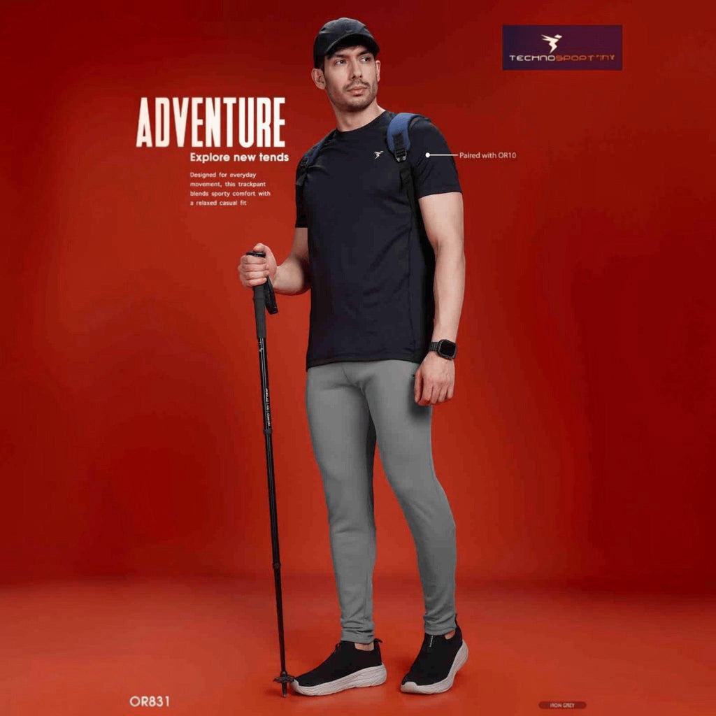 City Center Technosport men's slim fit iron grey performance track pants worn by a model with a hiking pole