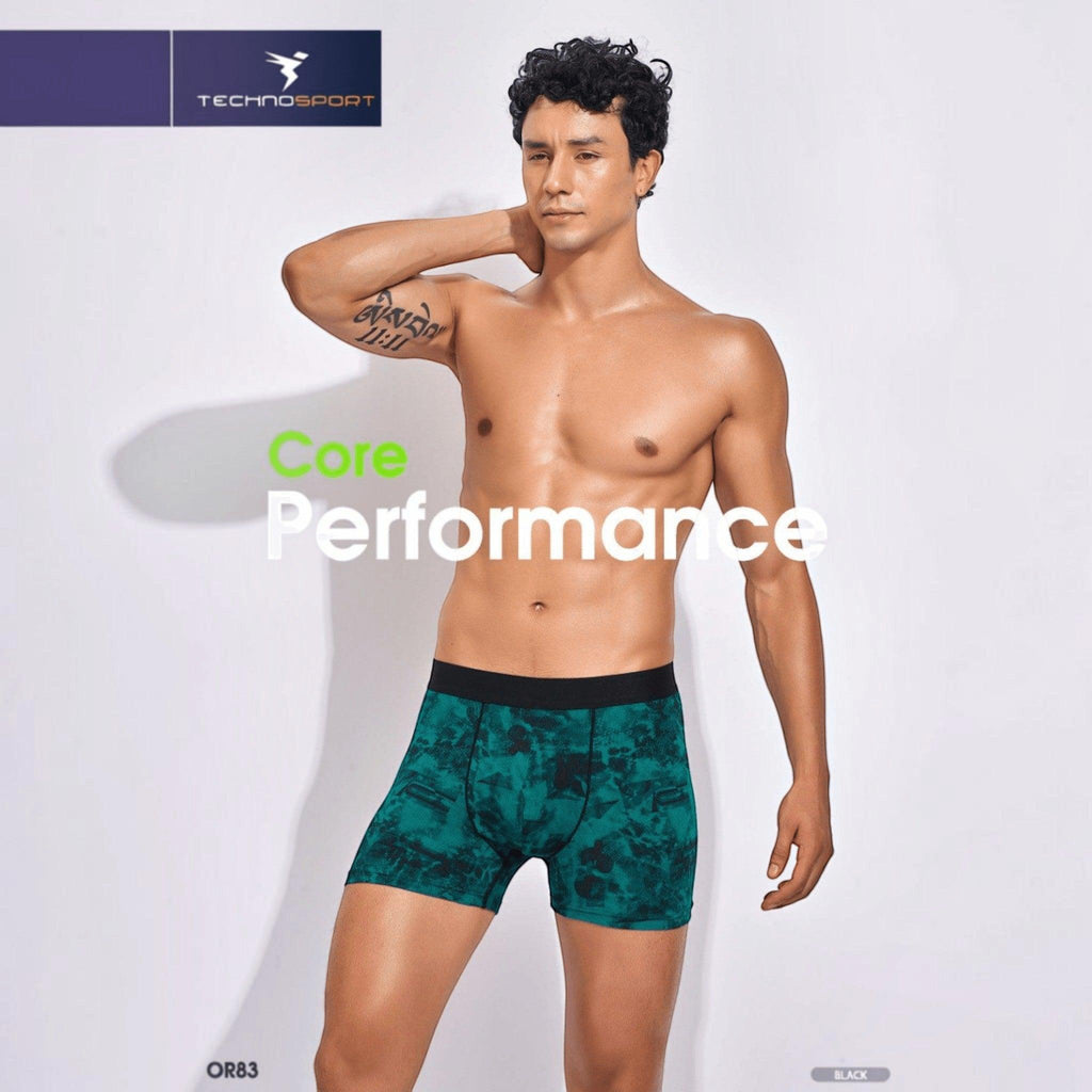 City Center Technosport Men’s Trunk OR83 in green all-over print with a black elastic waistband on a male model.