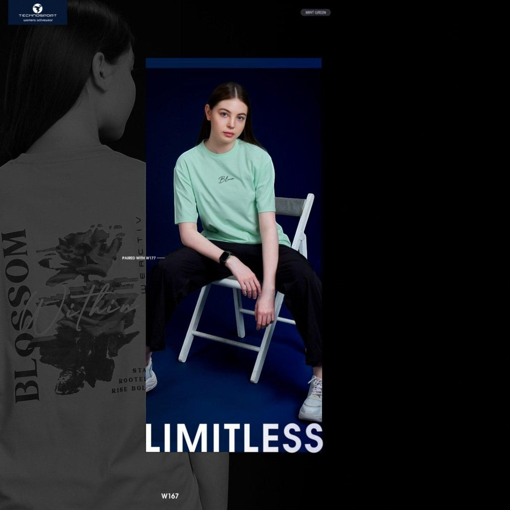 City Center Technosport women's mint green crew neck t-shirt with back graphic, worn by a model on a chair.