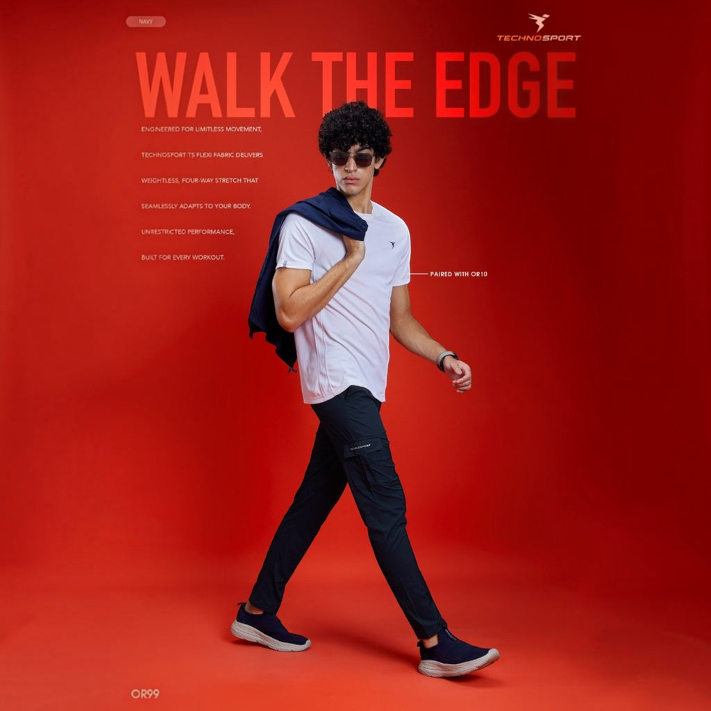 City Center model wearing navy Technosport TS Flexi solid woven cargo pants and a white t-shirt on a red background.