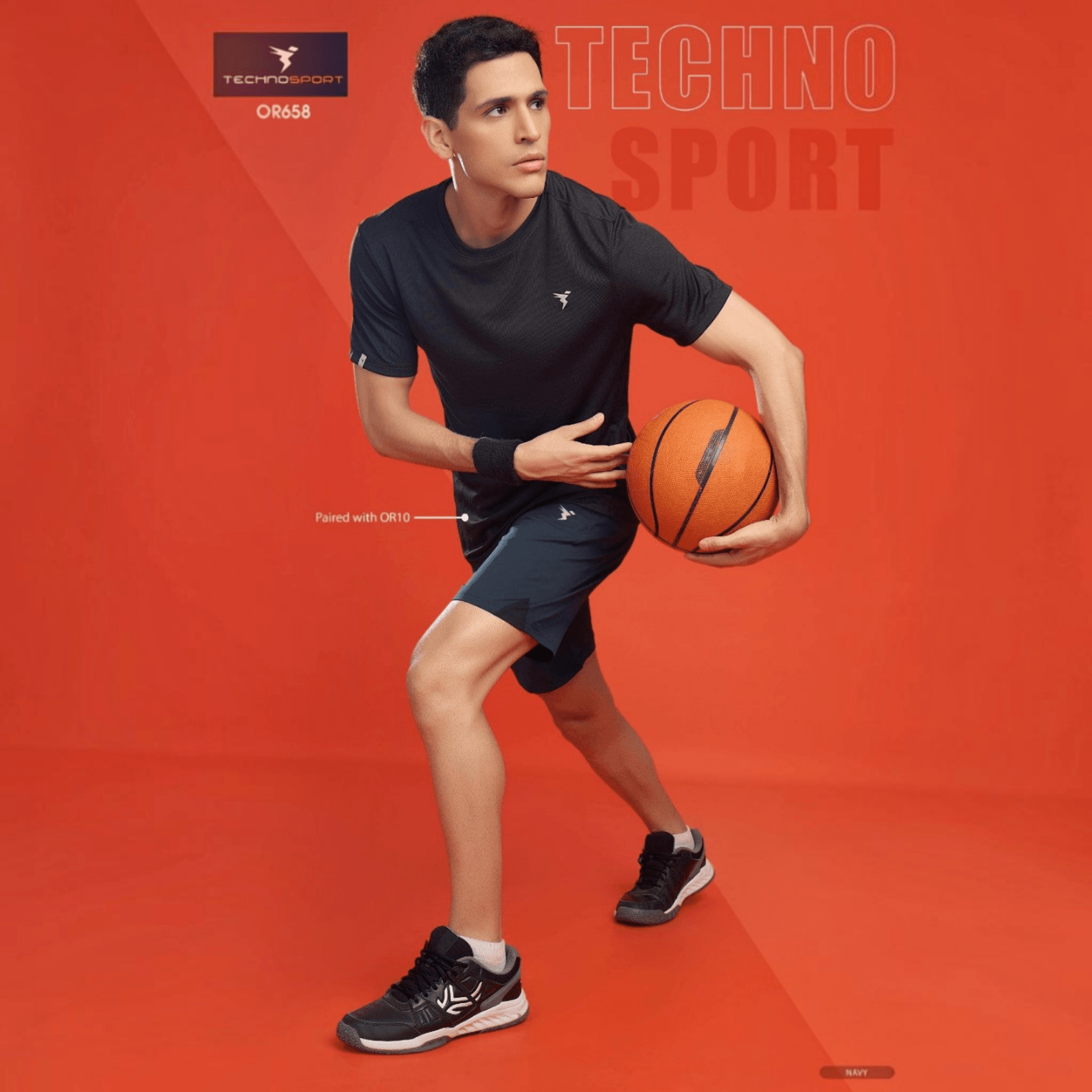 City Center model wearing Technosport navy 4-way stretch crispy shorts and black t-shirt holding a basketball