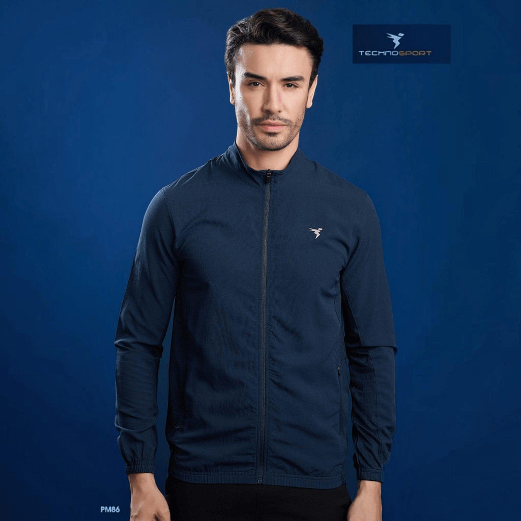 City Center model wearing a navy blue Technosport slim-fit hi-neck jacket made from lightweight moisture-wicking fabric.