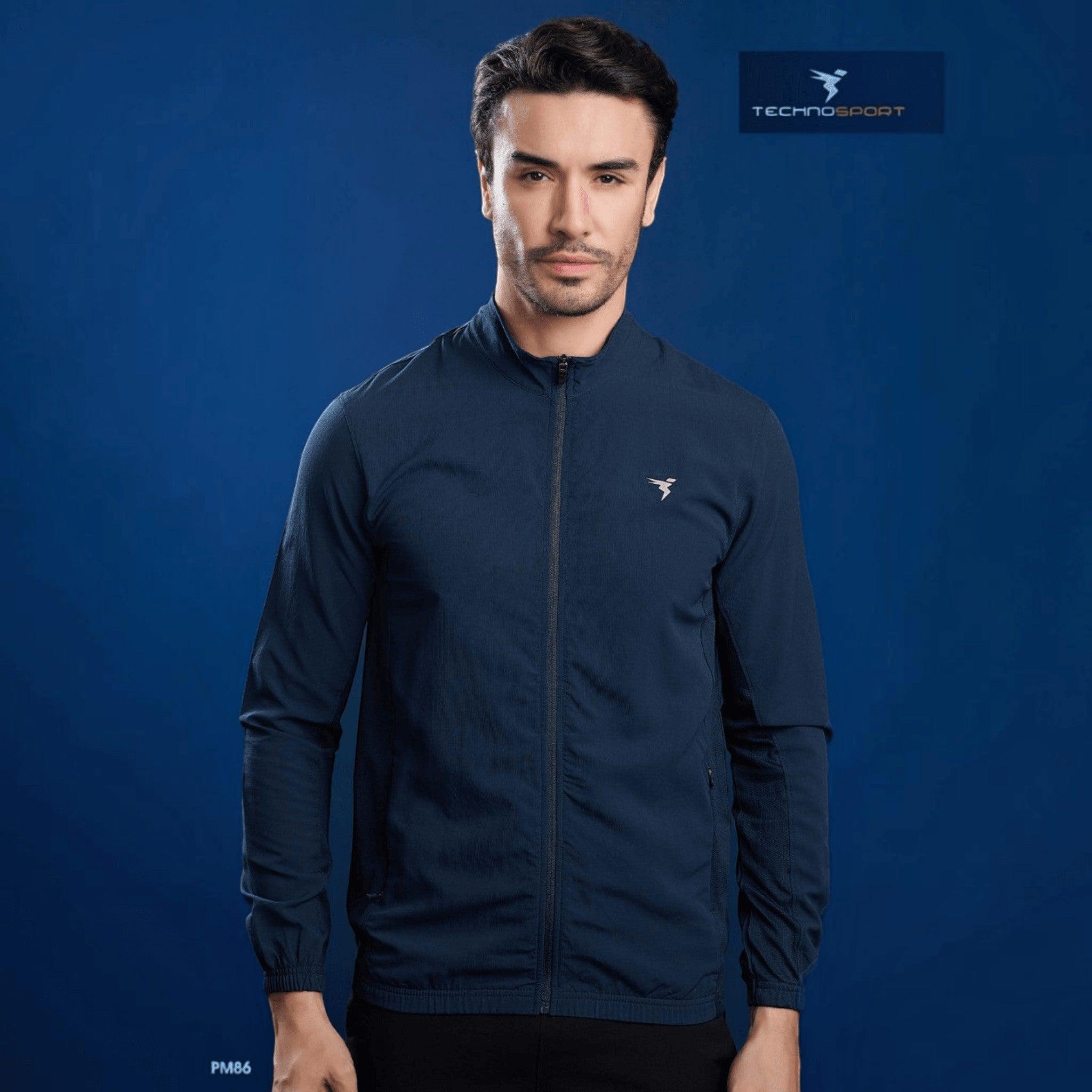 City Center model wearing a navy blue Technosport slim-fit hi-neck jacket made from lightweight moisture-wicking fabric.
