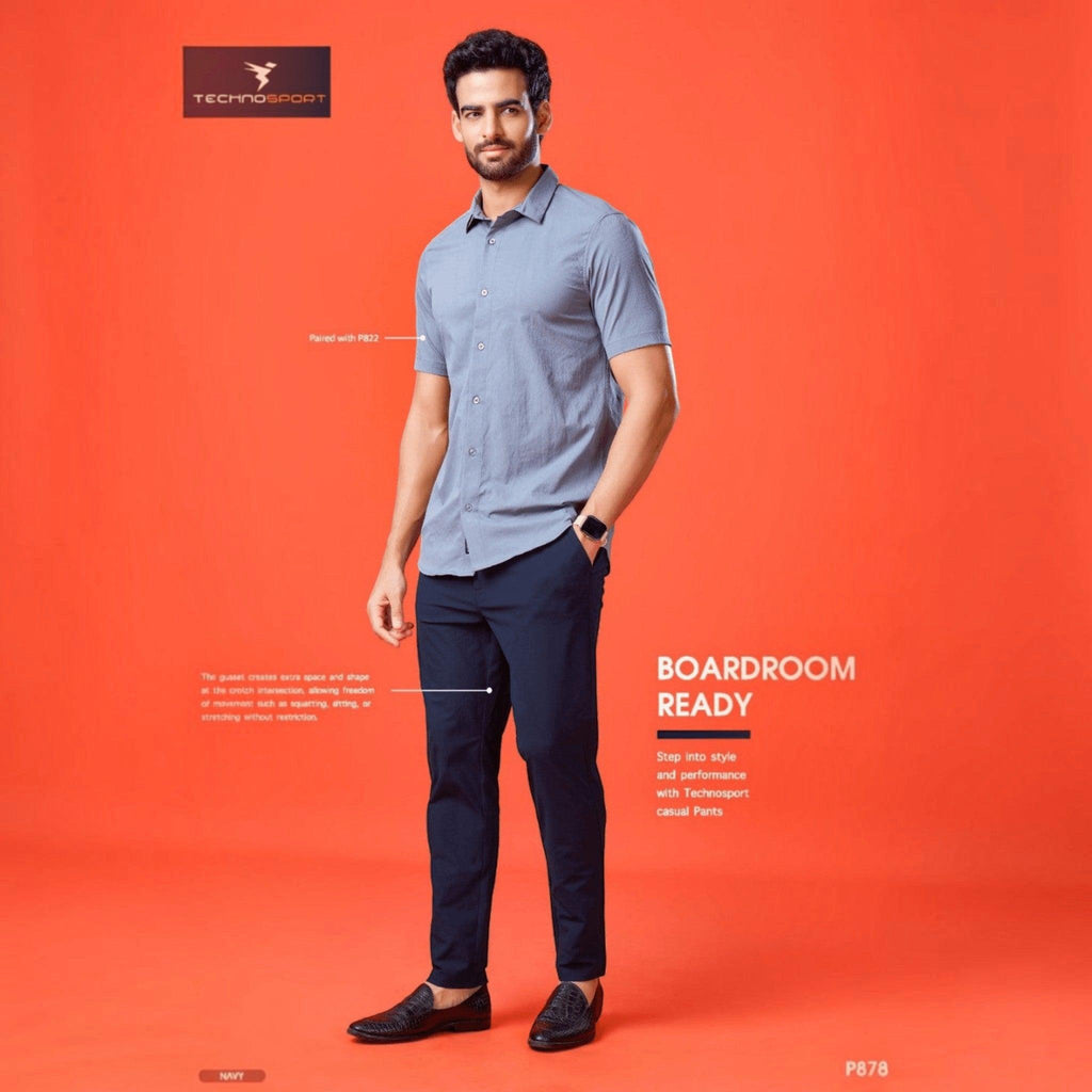 City Center Technosport navy blue 4-way stretch casual trousers worn by a man with a grey shirt on an orange background
