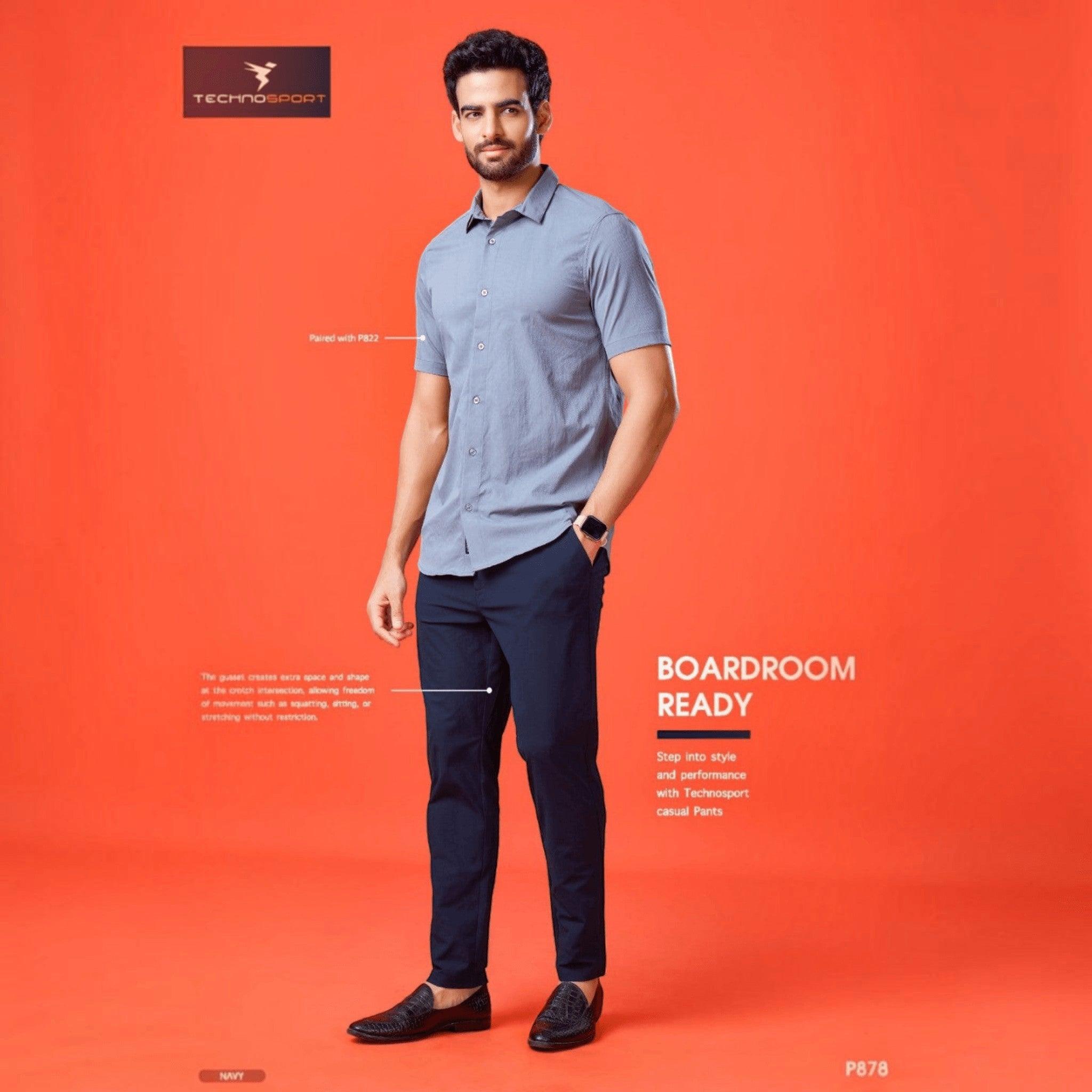 City Center Technosport navy blue 4-way stretch casual trousers worn by a man with a grey shirt on an orange background