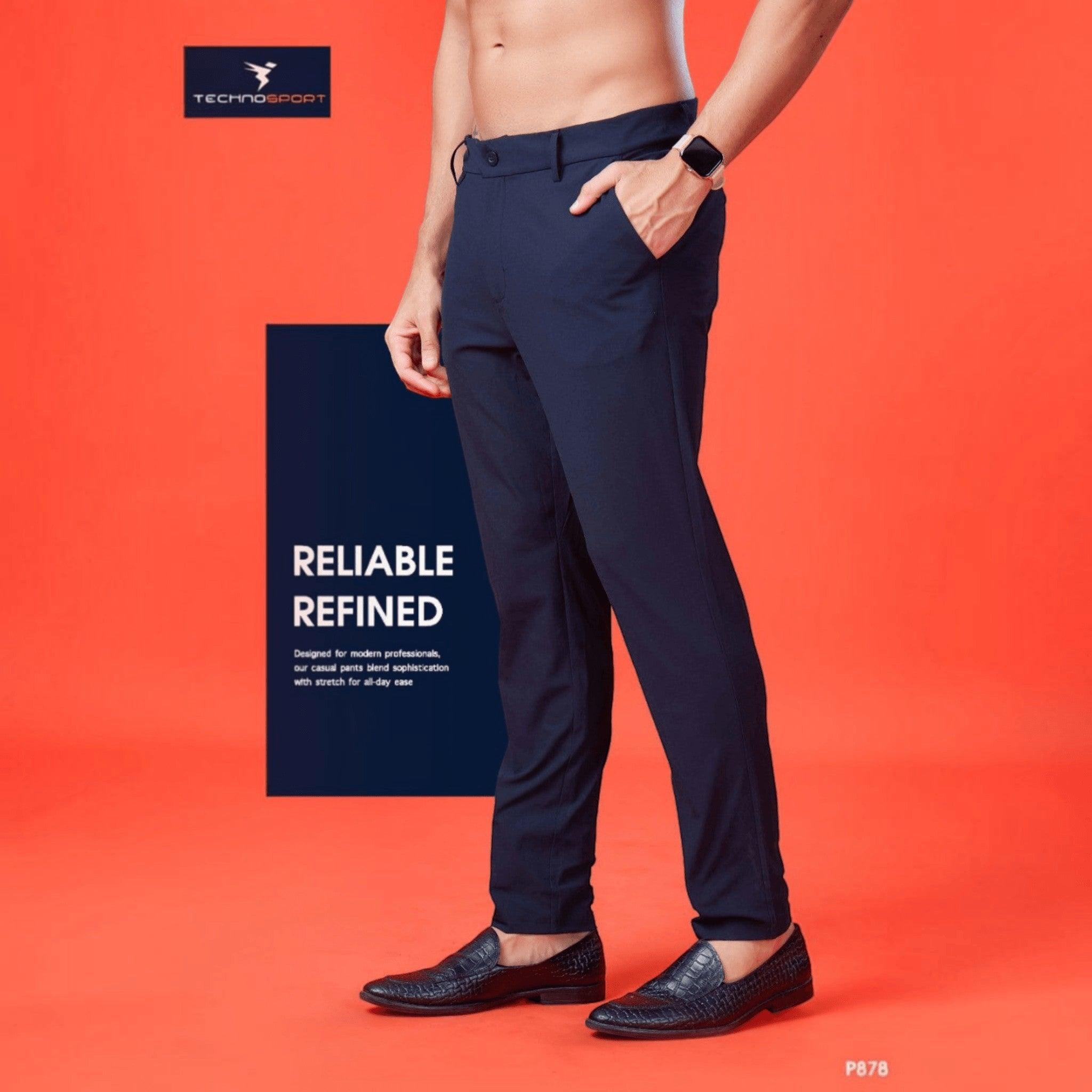 City Center Technosport navy blue 4-way stretch casual trousers with a regular fit worn by a man on a red background