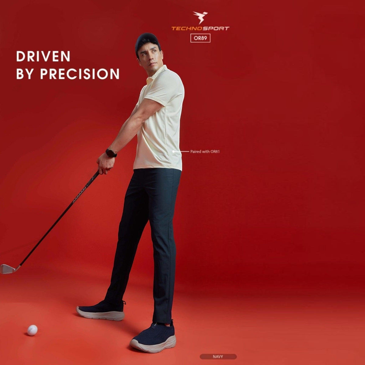 City Center model wearing Technosport navy 4-way stretch track pants while golfing against a red background