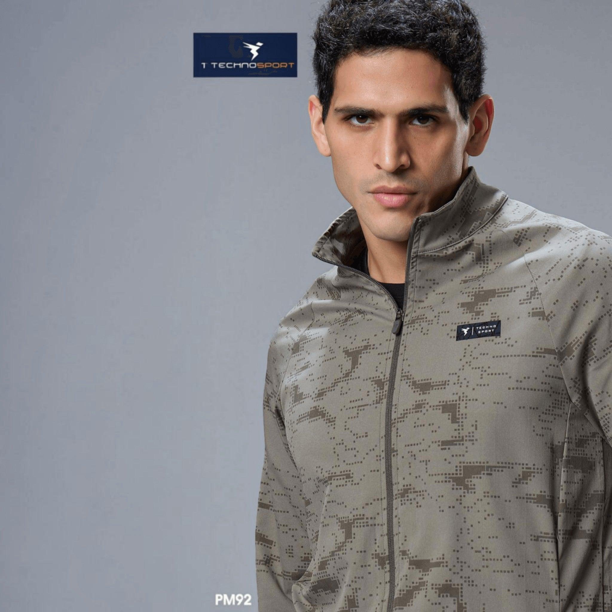 City Center Technosport olive green hi-neck jacket with digital camo print, full zip, and moisture-wicking fabric.