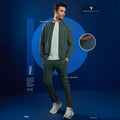 City Center Technosport olive green slim-fit hi-neck jacket worn by a model with matching trousers on a blue background