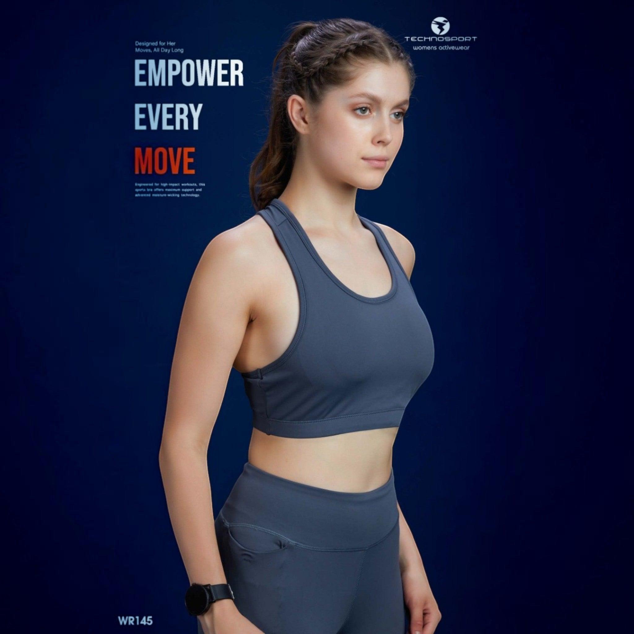City Center Technosport Elastoplus racer back sports bra in charcoal grey worn by a model against a blue background