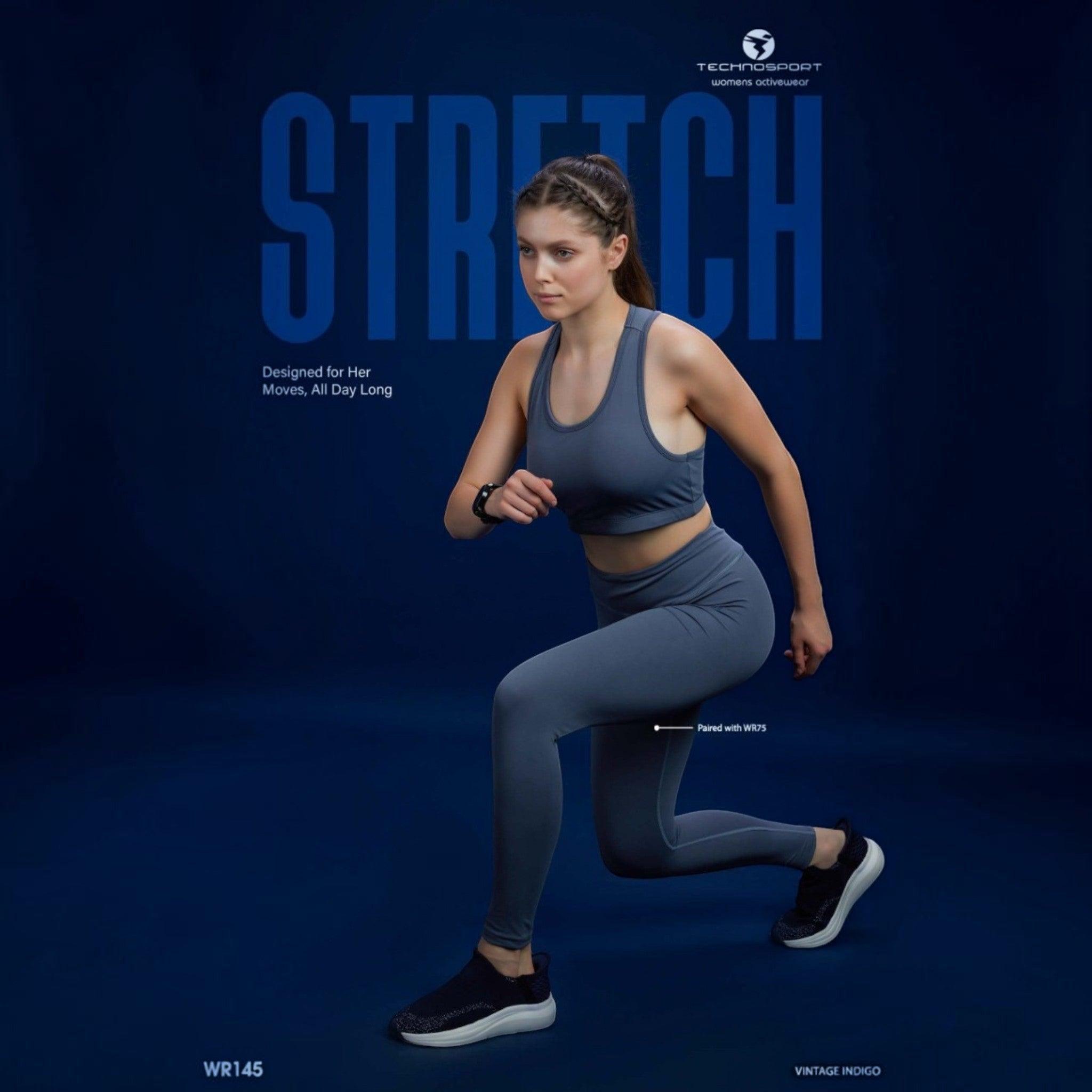 City Center Technosport Elastoplus racer back sports bra in vintage indigo worn by a woman in a lunge position