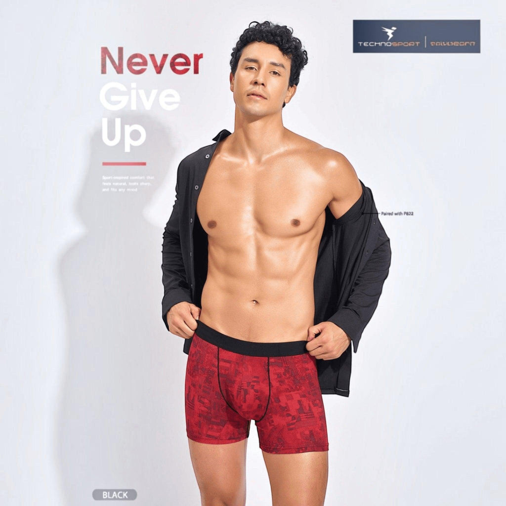 City Center Technosport men's red patterned performance trunk with a black elastic waistband worn by a male model.