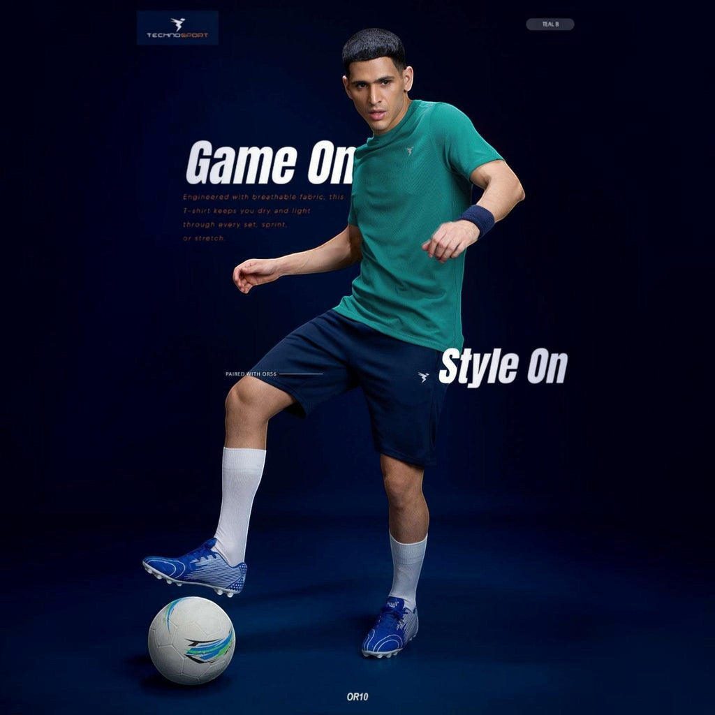 City Center Technosport teal crew neck slim fit t-shirt worn by a male athlete playing soccer in a studio setting.