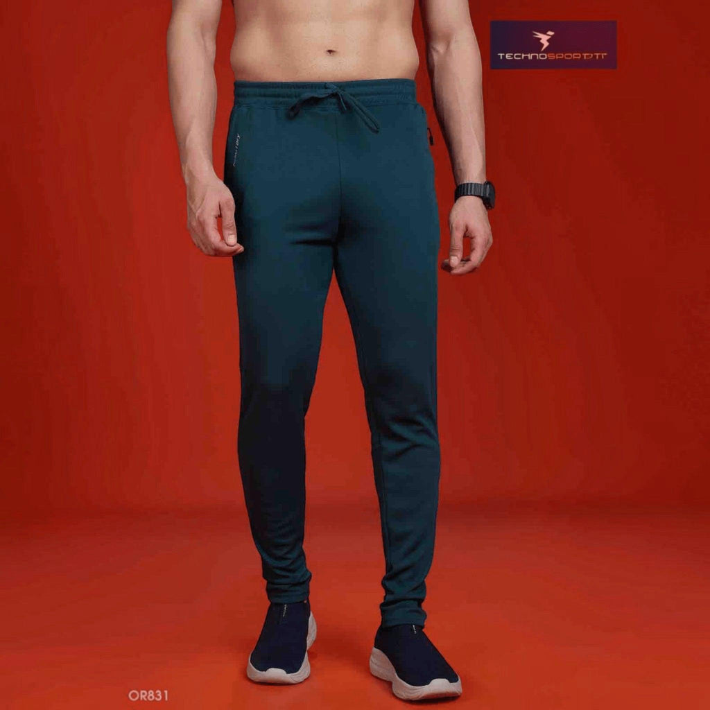 City Center Technosport slim fit teal track pants with moisture-wicking fabric and drawstring waist on a man
