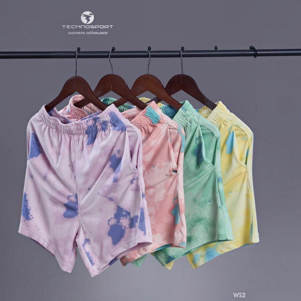 City Center Technosport womens activewear tie-dye shorts in various pastel colours hanging on wooden hangers