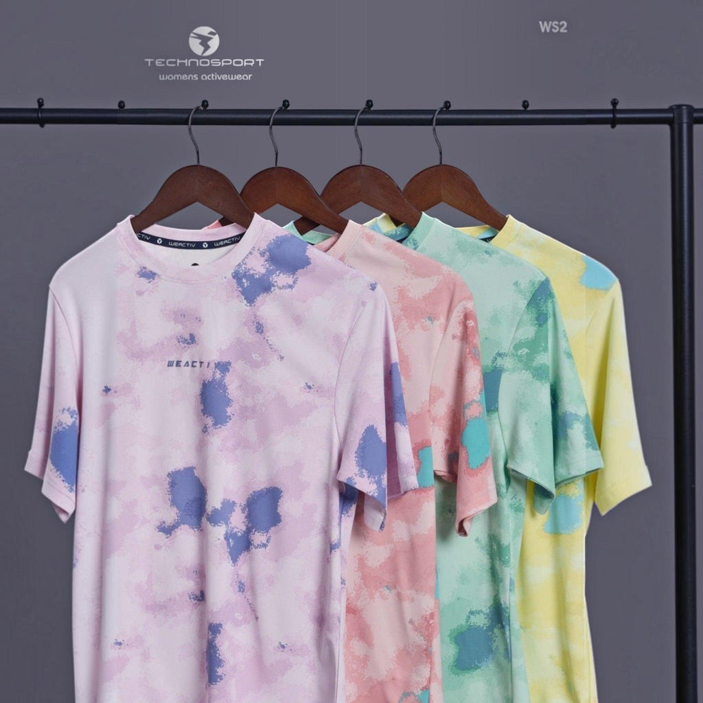 City Center Technosport womens activewear tie-dye t-shirts in pastel purple, pink, green, and yellow on hangers.