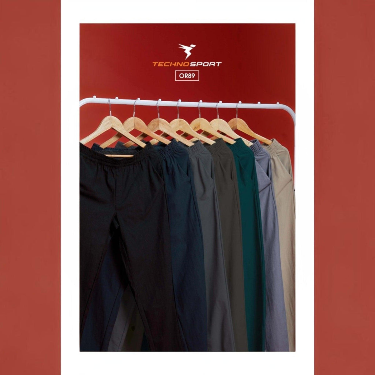 City Center Technosport DuraCool+ track pants in various solid colors hanging on a rack against a red background.