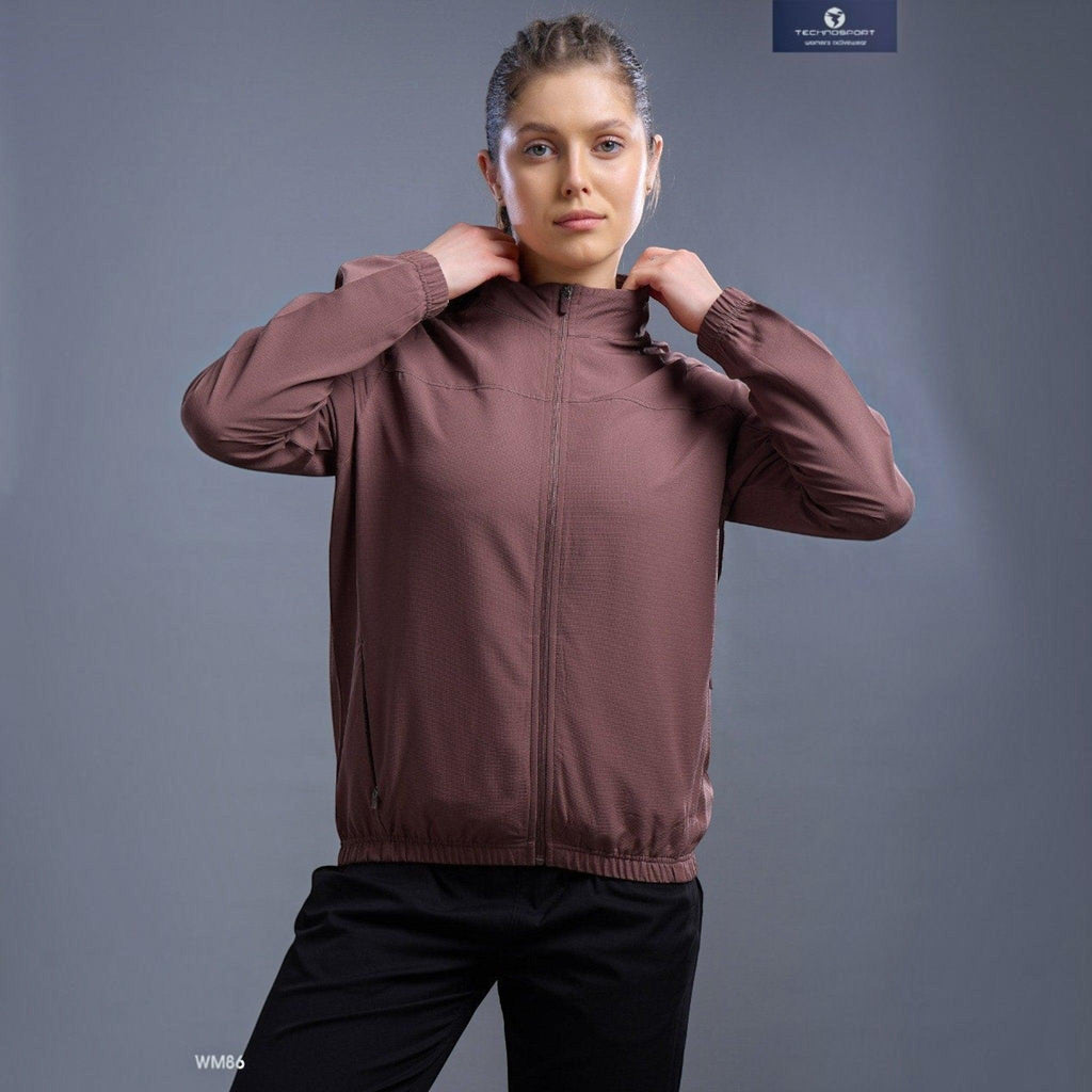 City Center Technosport WM86 brown zip-up athletic jacket with a hood worn by a woman against a grey background