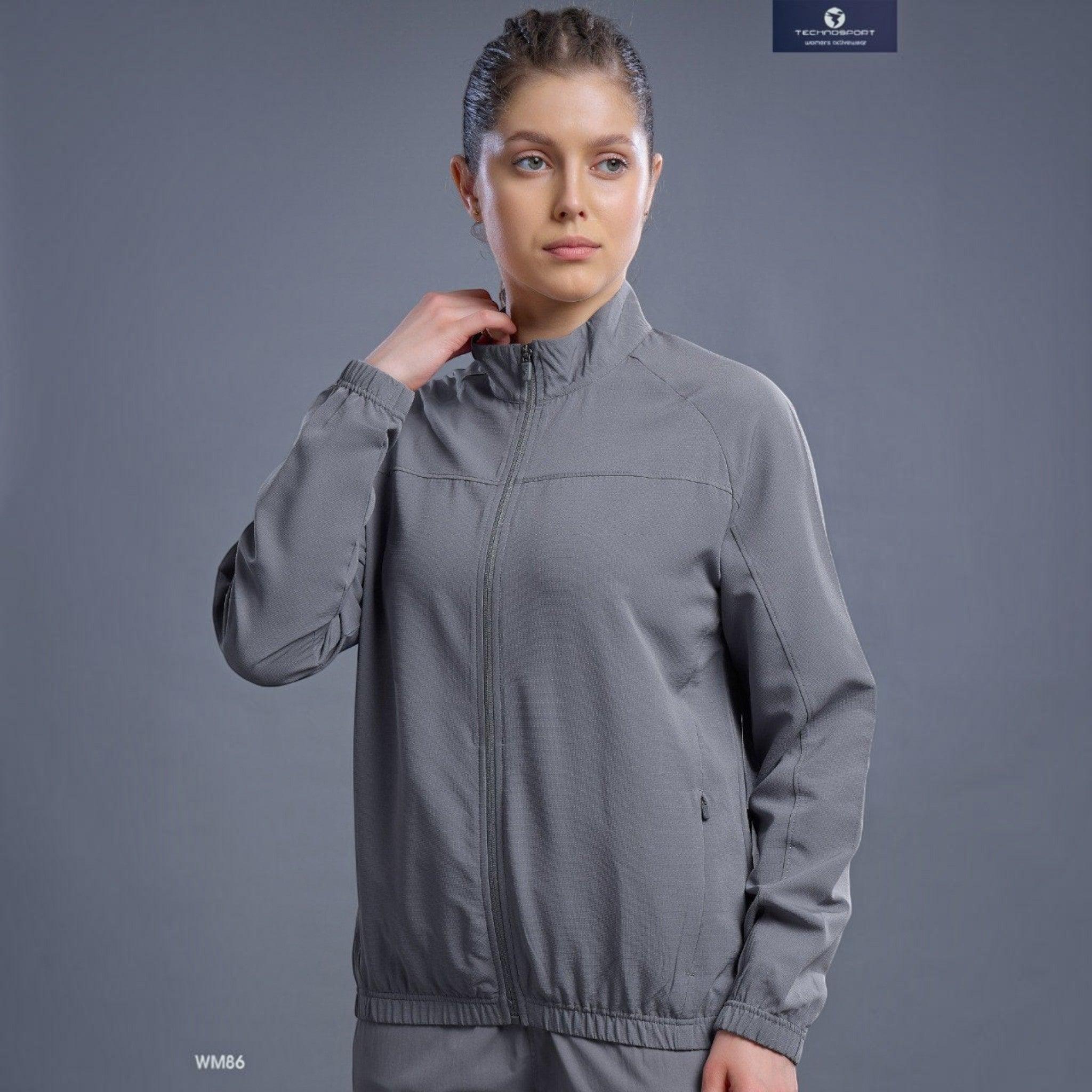 City Center Technosport WM86 grey zip-up athletic jacket worn by a woman with a high ponytail