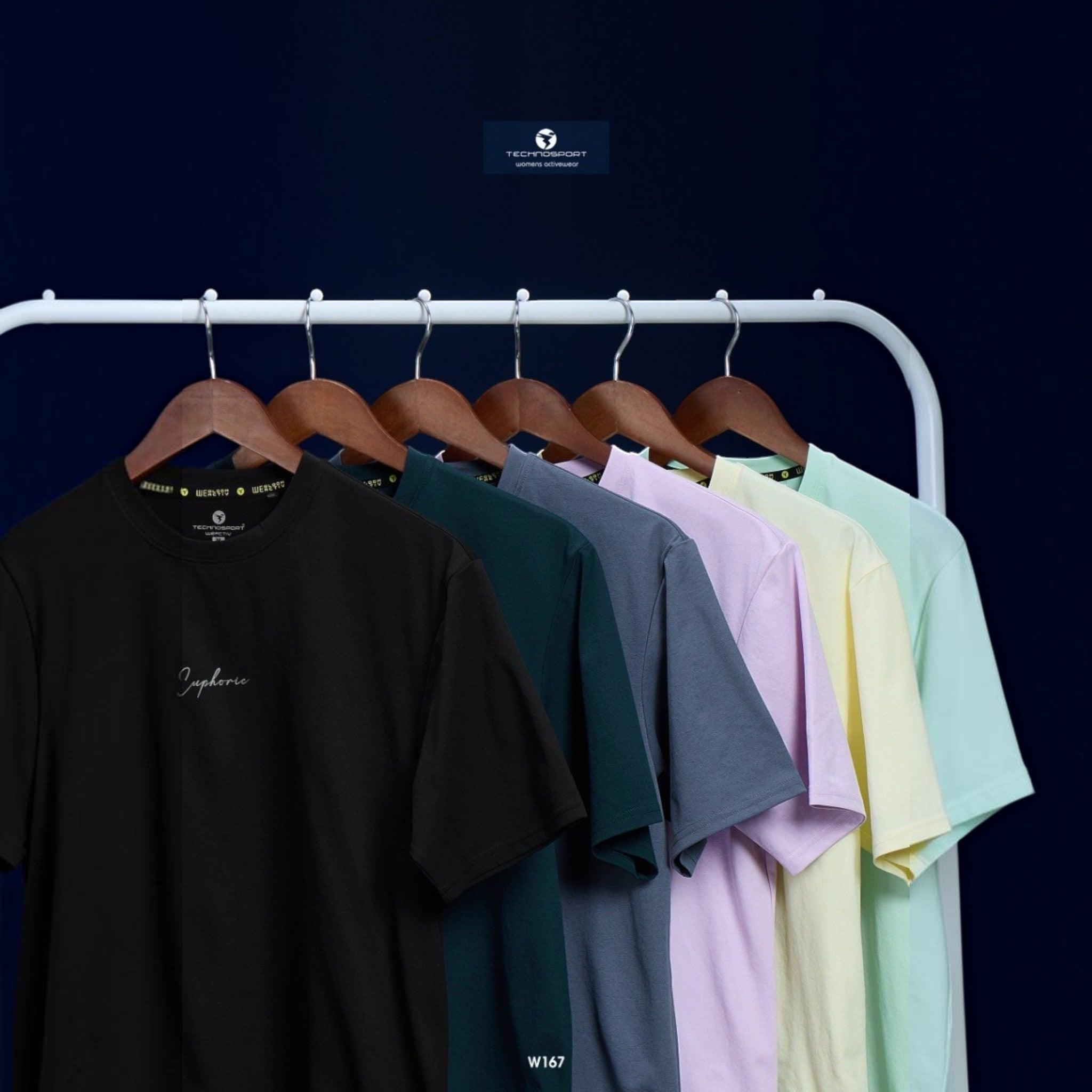 City Center Technosport women's crew neck t-shirts in various pastel and dark colors hanging on a clothing rack.