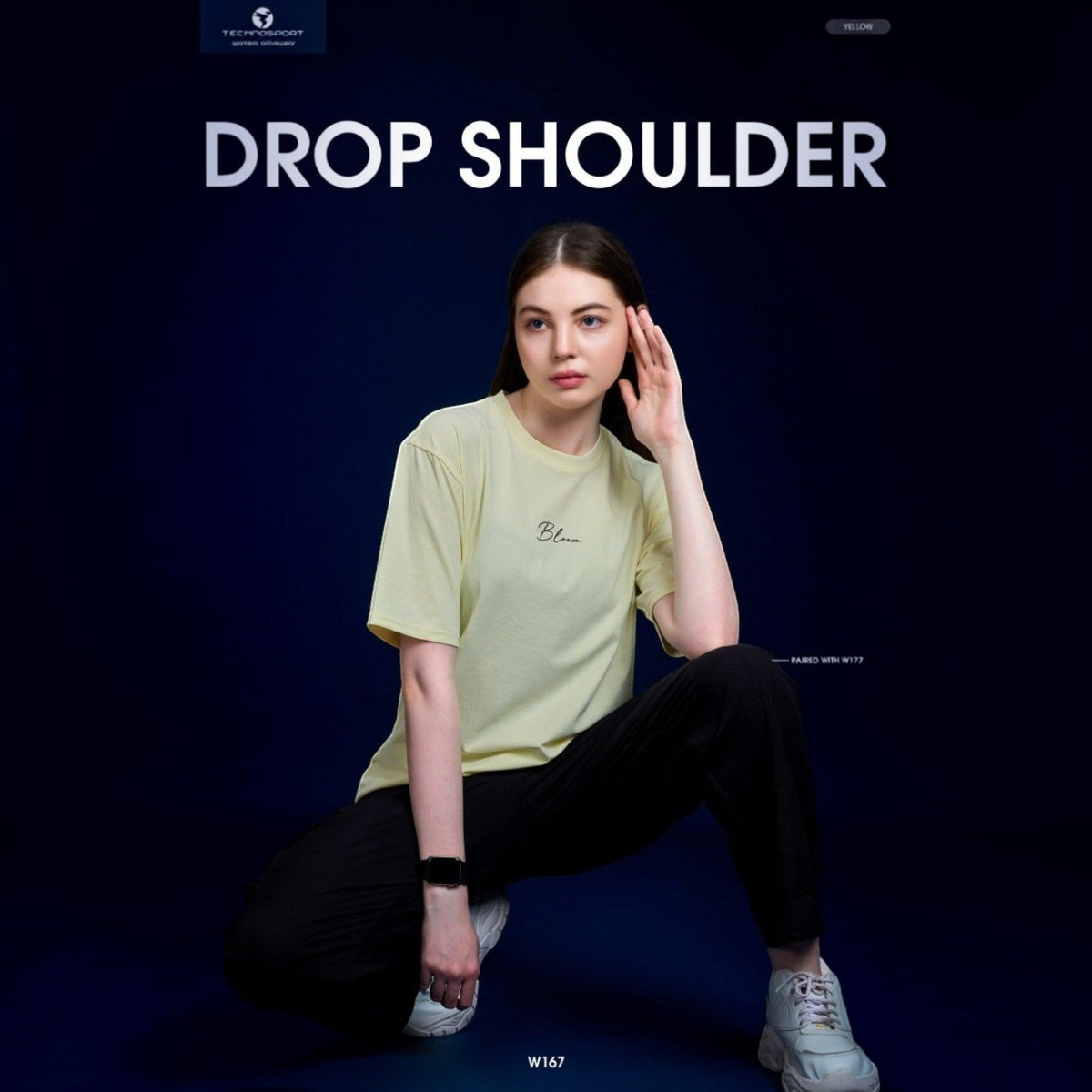City Center Technosport women's yellow drop shoulder crew neck t-shirt with minimalist front graphic on a model
