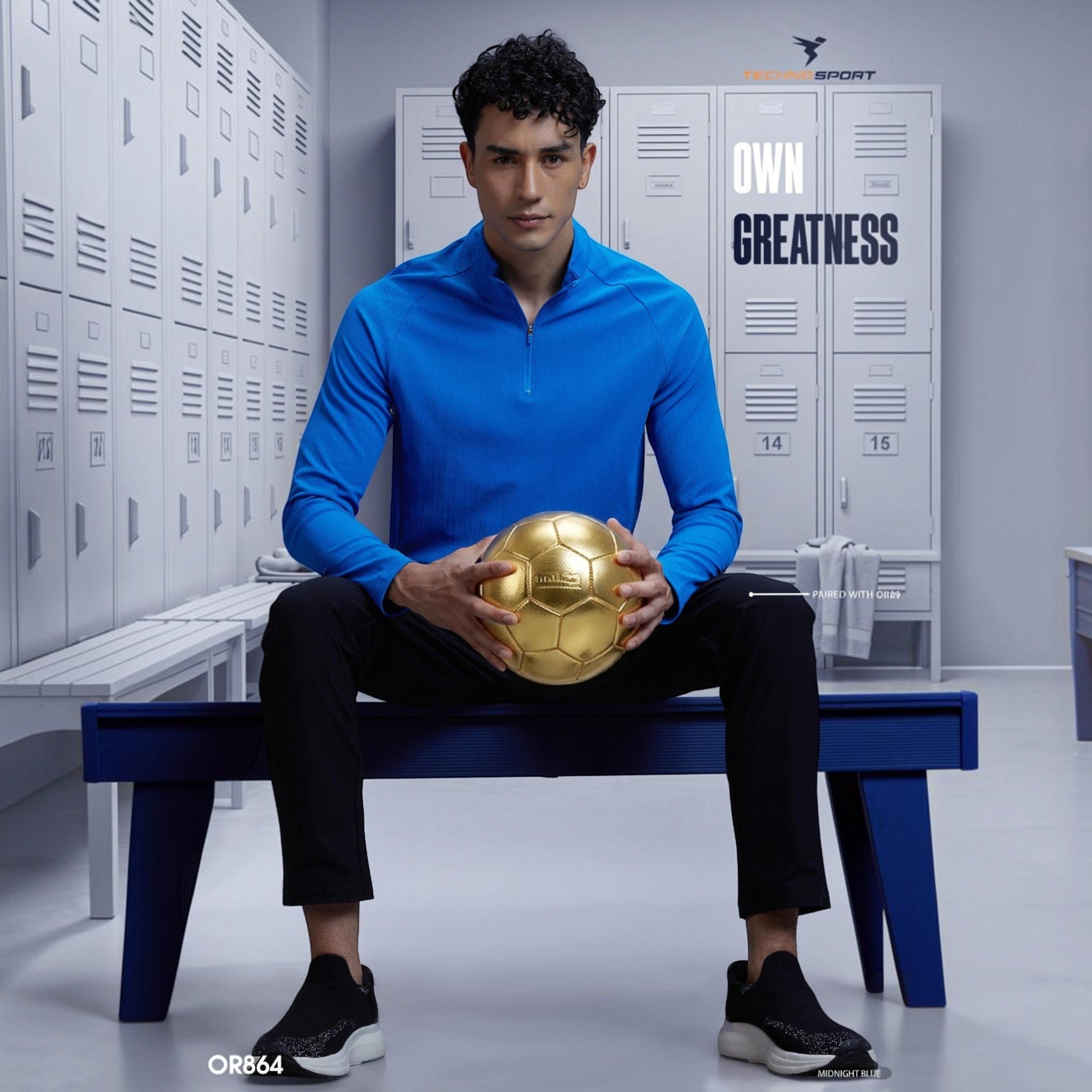 City Center TECHNOSPORTS OR864 blue high neck long sleeve athletic tee worn by a man holding a gold soccer ball