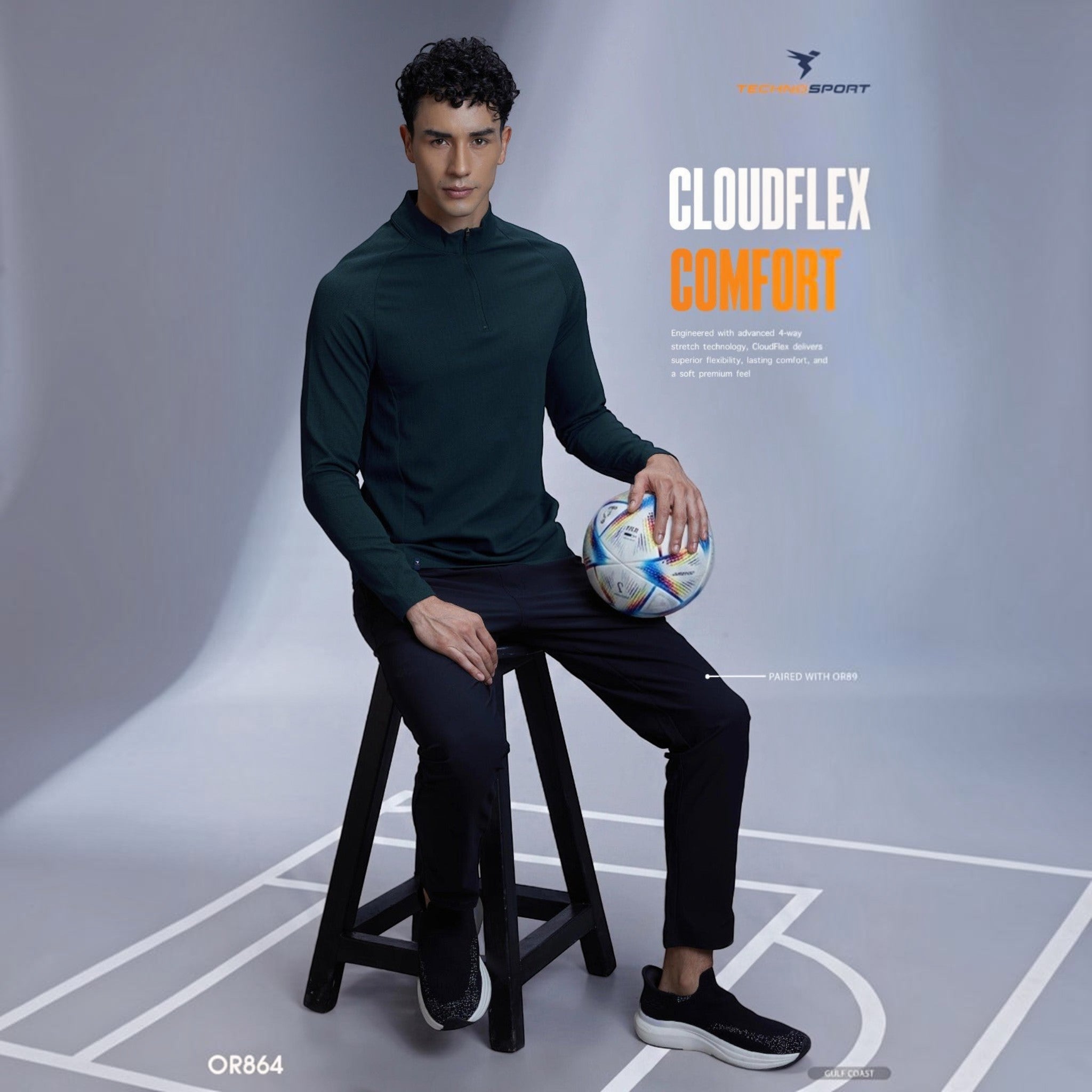 City Center model wearing a dark green TECHNOSPORTS CloudFlex high neck long sleeve tee with a soccer ball