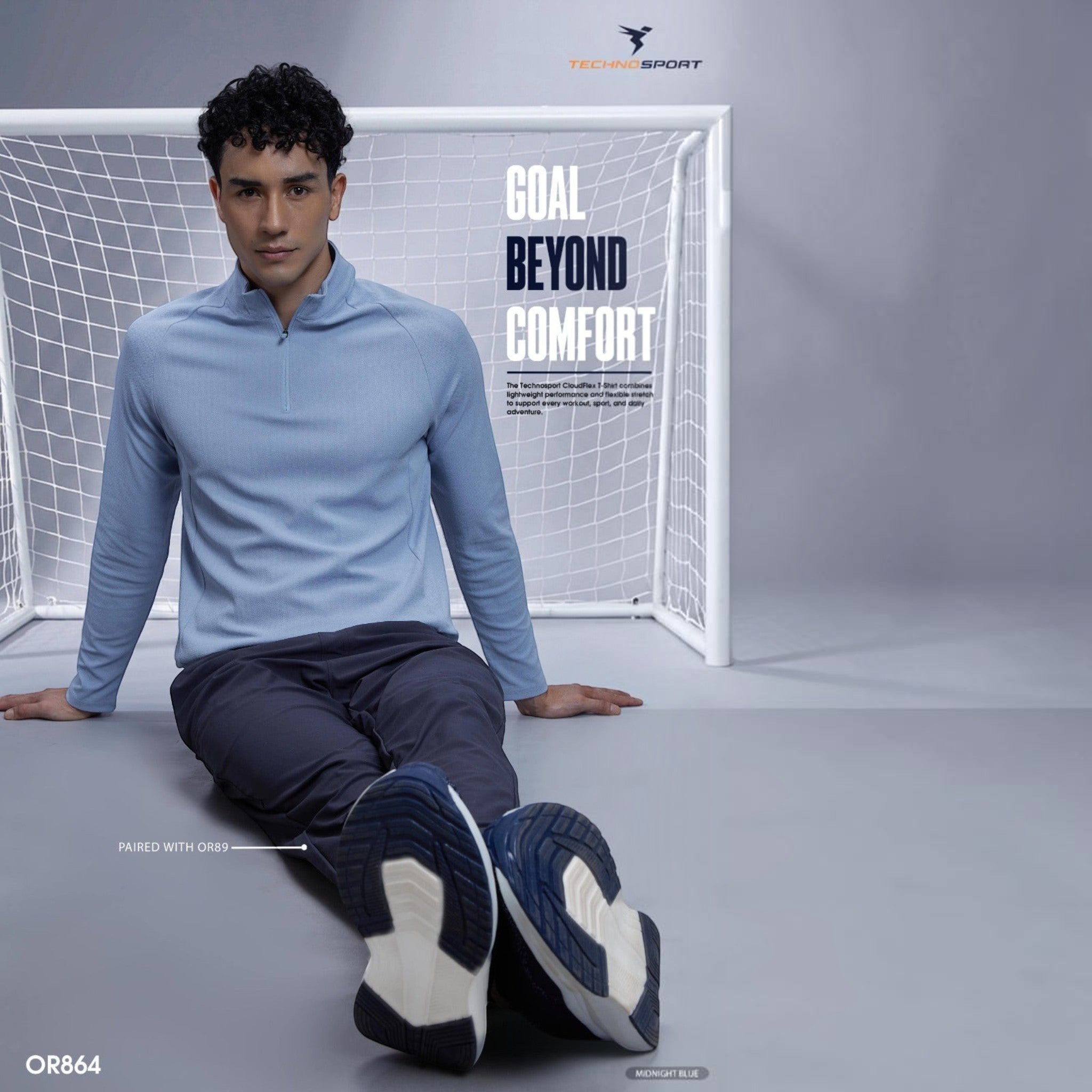 City Center model wearing a light blue TECHNOSPORTS CloudFlex high neck long sleeve tee with a quarter zip