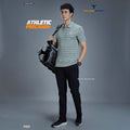 City Center model wearing a TECHNOSPORTS P969 aqua grey patterned performance polo shirt with black trousers
